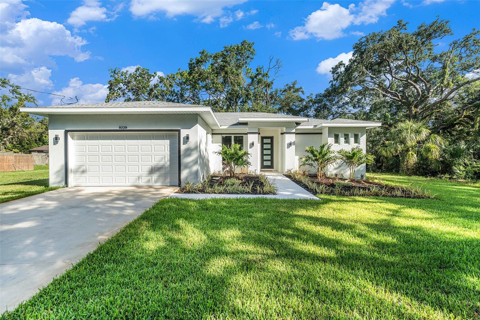 This beautiful new home is waiting for you. Every detail has been elegantly designed, offering both style and comfort in a highly sought-after location. With plenty of room to bring your RV, boat, or even add a pool, the possibilities are endless.
This custom-built gem was completed in April 2025 and is situated above the floodplain in the desirable Bass Lake Estates neighborhood. Priced below its appraised value, it’s a rare opportunity to own a spacious double lot just minutes from the Suncoast Parkway. Best of all, there are no HOA or CDD restrictions, giving you the freedom to enjoy your property your way.
Inside, the home features 3 bedrooms, 2 bathrooms, and an oversized 2-car garage. The open floor plan is enhanced by soaring ceilings, 8-foot doors, and a bright, cheerful color palette that creates a warm and inviting atmosphere. The expansive lanai is perfect for outdoor entertaining or relaxing in peace.
The gourmet kitchen is a showstopper with granite countertops, a waterfall island, white cabinetry with under-lighting, and stainless steel appliances. The master suite impresses with 10'4" ceilings and stylish barn doors leading to a spa-inspired bathroom that includes a sleek glass shower and a freestanding tub.
Nestled in a peaceful, up-and-coming area, this home offers the ideal blend of luxury and practicality. Whether you're hosting friends or enjoying the serenity of your spacious living areas, you'll feel right at home.
Don’t miss your chance to own this one-of-a-kind property. Call today to schedule your private showing!