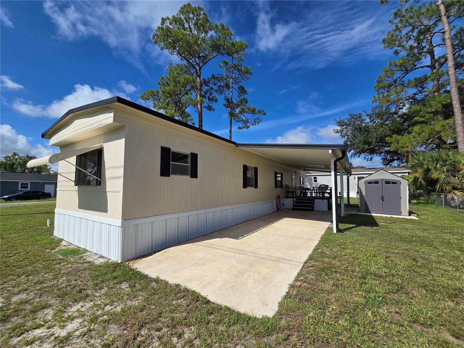 This MOVE IN READY home located in Pine Grove Park, a fisherman's paradise with easy access to the Alligator Chain of Lakes, is a must see. The boat ramp to Trout Lake is just down the street or catch the sunset at Lake Lizzie just a few blocks away. NO HOA! You OWN the land! This charming, updated, manufactured home sits on a beautiful corner lot and features 2 bedrooms, 2 full baths, a carport, storage shed and so much more! The freshly painted exterior and new skirting have great curb appeal, the new luxury vinyl plank flooring throughout the home adds elegance and ease of care. Newer heat pump AC, well pump and tank offer peace of mind. The split floorplan provides privacy and maximizes square footage with a spacious living room, kitchen with stainless steel appliances, room for a dinette and plenty of cabinets. Both of the bedrooms are good sized and have large built in closets. The primary bedroom has its own full bath with stand up shower, the main bathroom has a tub/shower combo. Enjoy the extended living spaces offered by the covered deck with lots of seating and the huge Florida room which is screened and has vinyl windows. This home is perfect for someone looking to move right in or would also make an excellent rental investment. Cash only. Make your appointment to see it today!