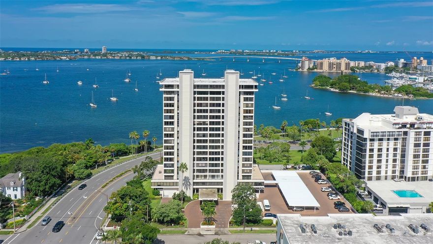 Welcome to Penthouse #2 at 770 S Palm Avenue in downtown Sarasota—a rarely available top-floor residence in the iconic Embassy House. Perched on the 18th floor, this two-bedroom, two-bath condo offers sweeping, unobstructed views of Sarasota Bay, the John Ringling Bridge, and the Gulf beyond. From this height, you’ll enjoy incredible privacy, no upstairs neighbors, and a daily front-row seat to some of the most breathtaking sunsets and sky color changes Sarasota has to offer. The layout is open and filled with natural light, featuring a practical kitchen, spacious living and dining areas, and a bright sunroom perfect for relaxing, entertaining and soaking in spectacular sunsets. Both bedrooms open onto a private terrace where you can take in morning sunrises and city views. Embassy House is known for its unbeatable bayfront location and strong sense of community. Amenities include a saltwater heated swimming pool, fitness center with bay views, electric car charging station, guest parking, outdoor grill, catering kitchen, and a recently updated modern lobby. Residents also enjoy the convenience of a concierge at the front desk, an on-site manager, and semi-private elevator access—to just two units. A shared laundry room for PH1 and PH2 is maintained by the HOA, along with service and replacement of washers, dryers, and A/C units. The building completed all structural integrity testing and had its roof replaced in 2024. The HOA fee includes cable, internet, water, sewer, and trash pickup—making it an easy, low-maintenance lifestyle. Just steps from Selby Gardens, Bayfront Park, Marina Jack, and all the dining, arts, and culture of downtown Sarasota, this penthouse offers the perfect blend of vibrant city living and serene waterfront views. Schedule your showing today and experience the view for yourself.