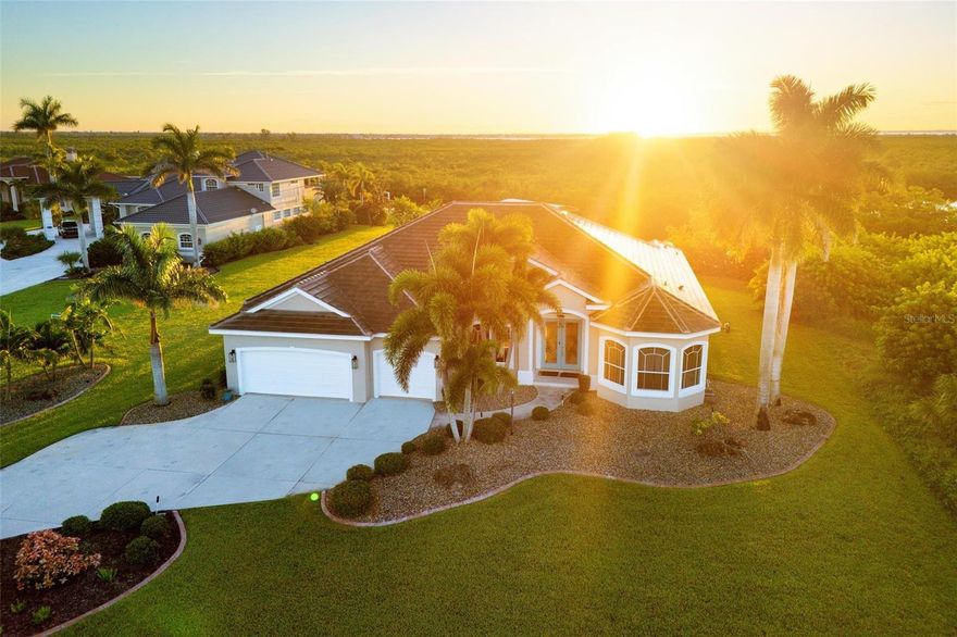 Embrace the art of coastal living at 19023 Midway Boulevard. A residence where refined design meets the freedom of water. Nestled on nearly an acre with 186 feet of sailboat-ready canal frontage, this home offers direct passage, with no bridges, to Charlotte Harbor and Gulf waters within minutes. A new paver walkway leads to the waters edge with direct boating access and an oversized dock with 16,000 lb. lift. Inside unfolds a gracious open plan, anchored by a dramatic great room crowned with a 12-foot coffered ceiling and a seamless zero-corner slider that erases the boundary between interior and lanai, while the expansive windows showcase the water from nearly every room. Overlooking the great room and open to the dining area, the chefs kitchen dazzles with new Cambria quartz counters and Thermador appliances, perfect for entertaining. When it's time to retire for the evening, there are 4 bedrooms, 3 full baths, including a generous primary suite and an inviting guest suite with private bath - each with access to the lanai and sparkling saltwater pool and spa. Located near the end of a quiet, private cul-de-sac, this home is secluded, but just minutes to fine dining, shopping, and major roadways. This exceptional property blends elegance, comfort, and the ultimate Florida lifestyle. *Please inquire about the assumable VA loan at 3.25%!!