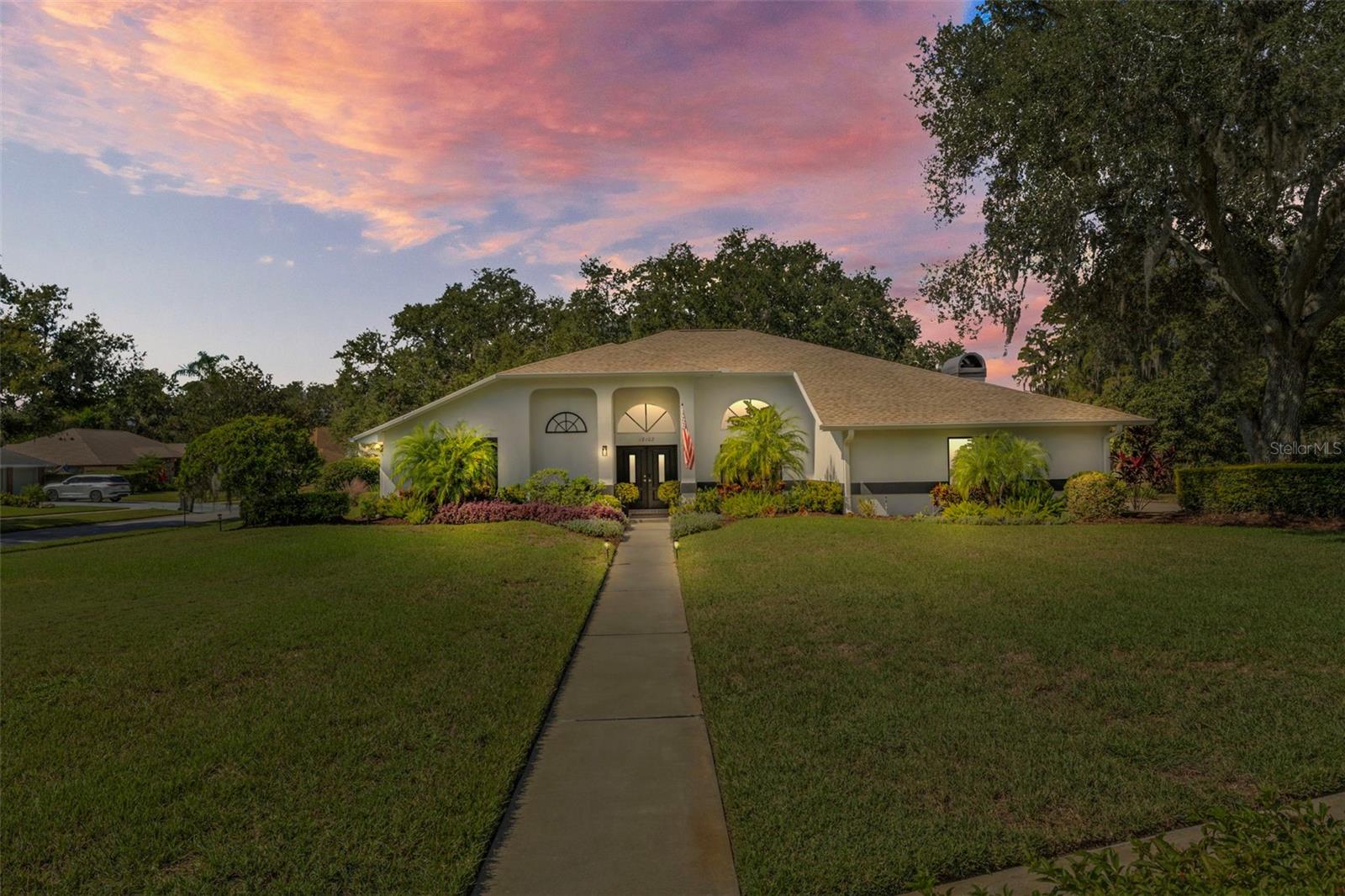 If you're looking for a beautifully updated and mechanically meticulous pool home in the heart of Lutz, Florida, this is it. You can move in and immediately start enjoying sunny mornings and summer evenings in this lovely home secluded in the guard gated community of The Manors at Crystal Lakes. Thoughtfully refreshed from top to bottom with over $150k in quality mechanical and finish updates, this lovely home offers the true Florida lifestyle of comfort, connection, and convenience. From the moment you step inside, natural light fills the open spaces, highlighting clean finishes and inviting rooms made for gathering. You’ll love the open plan family room with fireplace integrated with the kitchen with dining island, Shaker cabinets, granite counters and subway tile backsplash, making it the perfect entertaining space. The stunning new primary bathroom features European frameless shower, Italian glass tile and pebble-stone shower that feels like a spa retreat. The split-bedroom layout offers privacy for everyone, with two separate living spaces provide flexibility or relaxation with the second bedroom being currently utilized as an office. Outside, the screen-enclosed pool area is surrounded by mature trees, creating a private, peaceful retreat where you can sip coffee in the soft morning light or unwind as the sun sets. The neighborhood’s tree-lined streets and established vibe make it feel like home the moment you arrive. Located in Lutz’s sought-after Crystal Lakes area, you’re in the Steinbrenner High School zone and close to shopping, dining, and Tampa’s major highways - yet tucked away in a quiet, secure community that feels worlds away with added bonus of tennis and pickleball courts, playground and newly refurbished community center. This home has been pre-inspected and professionally cleaned in anticipation of your arrival! Major updates bring peace of mind: new roof with waterproof underlayment (2022), fresh paint (2022), electrical panel, water heater, and HVAC system (2022), new plenums on HVAC (2025), impact-rated double front doors (2025), gutter leaf guards (2024), new pool cartridge filter (2023), pool panel (2022), pool deck resurfacing and new drain (2025), new (leased and new owner can take over for $80mth or it can be removed) Culligan water filtration and conditioning system (2025), new dishwasher (2023), and washer/dryer (2022). **MAKE SURE YOU CHECK OUT THE PROFESSIONAL VIDEO AND VIRTUAL TOUR**