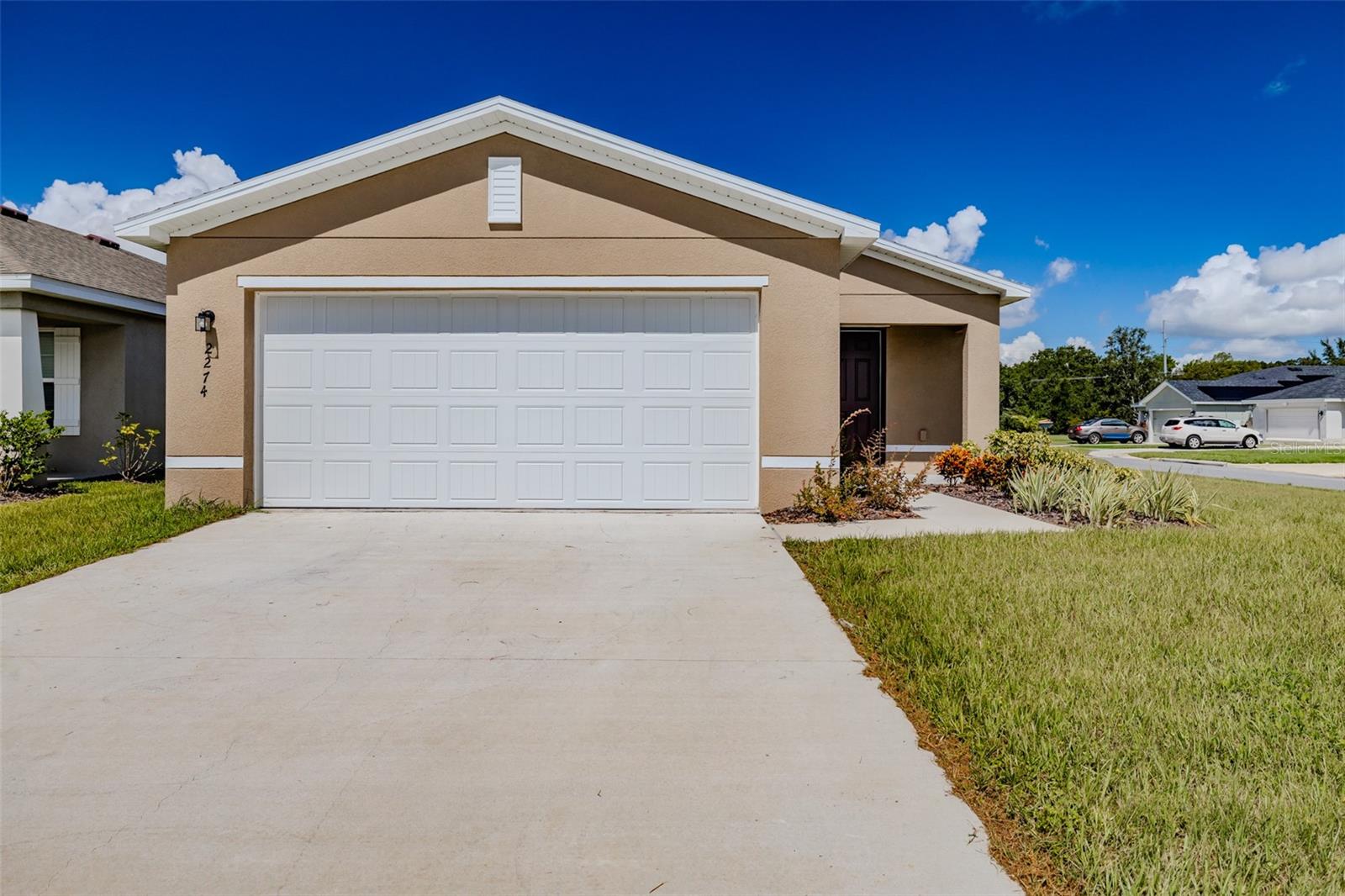 If you're looking for new construction, but don't want to wait on the builder, this home is move in ready! Welcome to the Eagle Hammock community. This 3 bedroom, 2 bath home with a 2 car garage offers an open floor plan. Off of the living room are 2 bedrooms and guest bathroom. The kitchen features granite countertops, a walk in pantry, stainless steel appliances and a sliding door to the back covered patio. The oversized laundry room is right off the kitchen, across from the primary bedroom. The primary en-suite includes a walk-in closet, double vanity and walk in shower. In the flower beds near the front door, there is a Hunter sprinkler system/misters. Don't wait, this home won't last long!