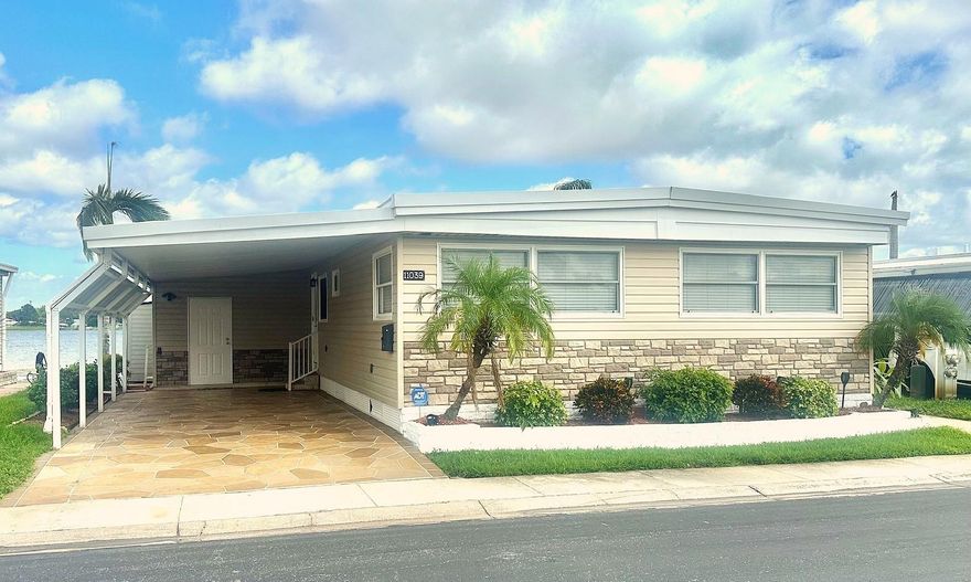 Hurry to See this this Inviting "Home & Gardens" spacious Seminole Lake Front Decorator Home! Be ready to be impressed upon entering the home, with the gorgeous open water view kitchen, with all the upgraded appliances & cabinets, ready to start entertaining & enjoy! Granite Counter tops, Wine Refrigerator, Cast iron sink, and so much more! Designer Laminate floors, & electric shades for updated insulated wall to wall windows, to enjoy your panoramic gorgeous water view! All new marble enhanced guest bathroom, Insulated Roof Over 8/21, Central Air/Heat '22, Vinyl Siding, drywall interior, and more to see! Bring your bathing suit to enjoy your wonderful Hot Tub, while relaxing on your new back decking & lake front dock. Fantastic 9x11 Workshop/Shed, with  updated Washer & Dryer! Expanded decorator painted driveway, with covered parking for 2+ cars! Do not wait to see this Resort Inspired Haven, in the 5 Star, 55+, Fun & Active Seminole Lake Resident Owned Community! Small pet ok! Cash only! Asking $279,000, includes the $55k share! Low $316. mo. maint. fee