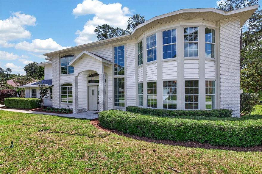 Completely renovated and move-in ready, this beautifully reimagined 5-bedroom, 3-bath residence offers 3,352 square feet of stylish living space in the heart of Palm Coast. Positioned on a private homesite with mature landscaping and a peaceful backyard setting, this stunning home showcases a bright, modern interior with thoughtful designer finishes throughout. The impressive two-story entry welcomes you with soaring ceilings, abundant natural light, and wide-plank luxury flooring that flows seamlessly throughout the home. At the center of the residence is a chef-inspired kitchen featuring custom shaker cabinetry, quartz countertops, oversized center island with seating, farmhouse sink, stainless steel appliances, designer lighting, and an open-concept layout ideal for entertaining. Multiple living and dining areas provide exceptional flexibility for both everyday living and hosting guests. The spacious primary suite offers a relaxing retreat complete with a spa-inspired bath featuring an oversized walk-in shower with custom tilework and elevated finishes. Additional bathrooms have been beautifully updated with stylish fixtures and modern coastal-inspired design. Enjoy indoor-outdoor living with French doors opening to a large screened lanai and private pool area overlooking a tranquil natural preserve backdrop. Additional highlights include updated lighting and fixtures throughout, oversized windows, fireplace, generous guest bedrooms, and a desirable floor plan offering space and versatility for a variety of lifestyles. Conveniently located near shopping, dining, schools, golf courses, parks, and just a short drive to the beaches.