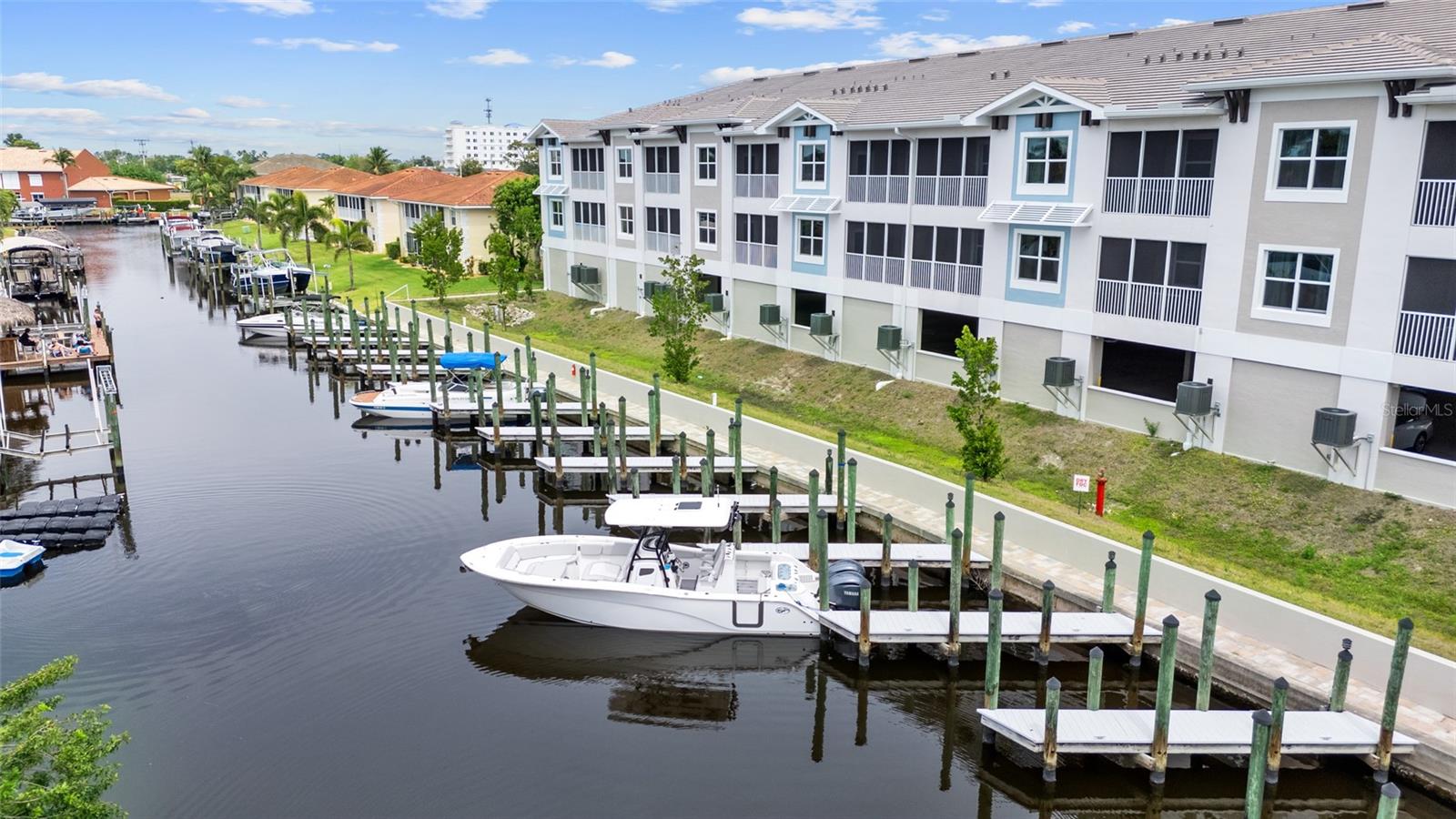 Brand-New Gulf Access Condo – Turnkey & Fully Furnished! Don’t miss the only newly built Gulf access condo community in Cape Coral! Bacino Vista is an exclusive 16-unit waterfront development offering direct, no-bridge access to open water with a deeded 18-ft boat slip. This modern 3-bedroom, 2-bathroom condo, built in 2023, is fully furnished and move-in ready. The open floor plan features 9-foot ceilings, recessed lighting, and porcelain tile flooring throughout. The chef’s kitchen is designed for both style and functionality, boasting granite countertops, a walk-in pantry, stainless steel appliances, chic pendant lighting, and a breakfast bar with seating for four. The primary suite offers direct balcony access, a walk-in closet, and a spa-like en-suite with dual sinks and a luxurious walk-in shower featuring subway tile and a rainfall shower head. The guest bath includes a soaking tub. Relax on your screened-in lanai with peaceful canal views, or enjoy the resort-style saltwater pool surrounded by tropical landscaping. Additional perks include two assigned garage parking spaces, a locked 6’x8’ storage unit, a common elevator, and guest parking. Located near downtown Cape Coral, you'll have easy access to dining, shopping, and entertainment. Future enhancements, including the renovated Cape Coral Yacht Club, public beach expansion, and the Bimini Basin’s upcoming waterfront dining and retail, will further elevate this prime location. With major development projects underway, these condos are poised for significant appreciation. Whether you're seeking a full-time residence or a high-performing rental investment, this is an opportunity you won’t want to miss. Schedule your private tour today!