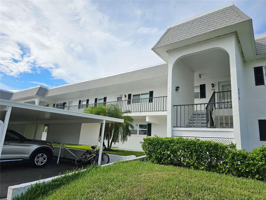 Wake up every morning to sweeping direct Bayfront views in this welcoming 2-bedroom, 2-bath condo in a lively 55+ community. Perched on the second floor of a two-story building with both stairs and an elevator, this home offers comfort, convenience, and plenty of Florida charm. The fully equipped kitchen features warm butcher block countertops, a pantry, washer/dryer and a handy breakfast bar, flowing easily into the open living/dining combination. The main bedroom is designed for relaxation with a king bed, walk-in closet, and a bathroom boasting an updated shower and granite vanity top. Guests will feel right at home with their twin-bed suite and private bath with a tub/shower and doors. Best of all, the glass-enclosed patio gives you front-row seats to stunning Bayfront views—perfect for bird watching or simply unwinding with a cup of coffee. Enjoy the convenience of a detached covered carport, perfect for keeping your car out of the hot sun. The community is buzzing with activity, offering a full clubhouse, library, craft room, billiards, small exercise room, heated pool, tennis, shuffleboard, putting green, bird sanctuary with picnic area, boat docks, trailer/boat storage, and endless activities. And when you’re ready for the sand, our beautiful beaches are just a couple of miles away. This one truly combines a peaceful bayfront setting with the best of active Florida living.