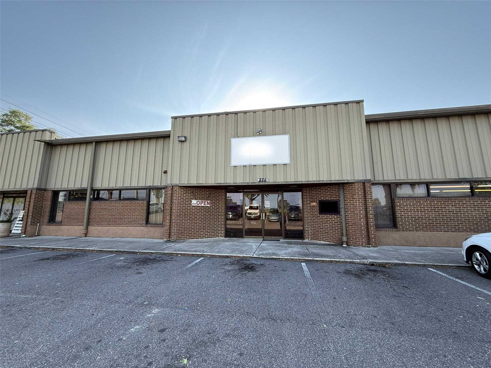 Available July 2025, this 8,235 SF flex space at the Ocala Airport Commerce Center offers an ideal combination of showroom, office, and warehouse functionality. Located directly off SW 60th Avenue with an average daily traffic count of 17,800, the property provides excellent visibility and accessibility. The front-facing office/showroom area features an open floor layout, two private offices, a breakroom, and two restrooms—perfect for retail or administrative use. The expansive, open-span warehouse includes both a dock-high loading bay and a ramp-accessible grade-level door, accommodating a wide range of operational needs.