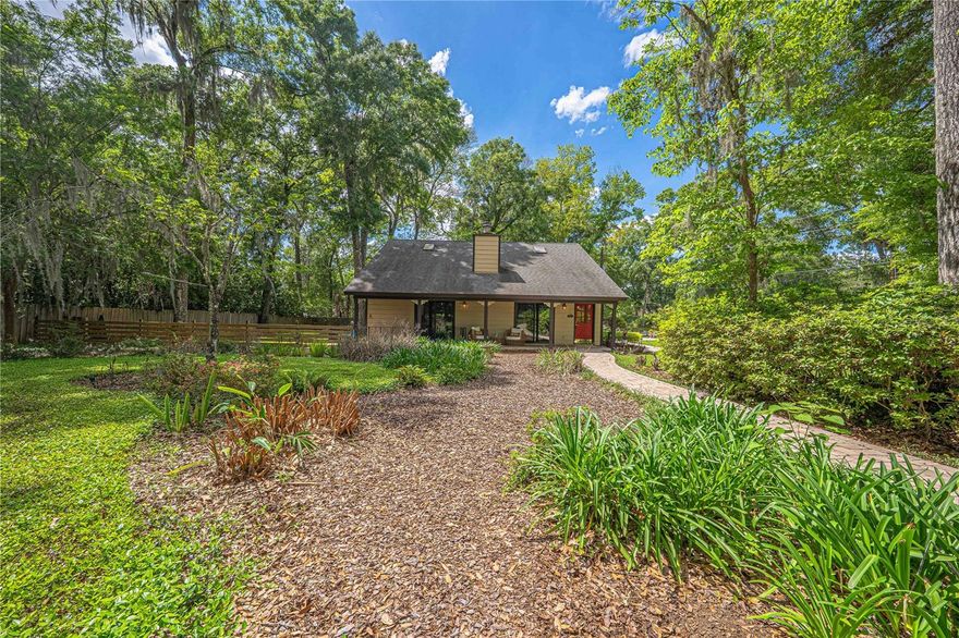 Nestled on a generous .55-acre corner lot, this nature lover's dream offers privacy, charm, and
thoughtful updates throughout. A circular driveway welcomes you home, complemented by a
one-car garage and additional carport for convenience.
Step inside to soaring 17-foot ceilings in the main living and dining areas, accented by rich wood
ceilings and beautiful real wood flooring that flows throughout the home. A striking brick wall with a
cast-iron wood-burning stove creates a cozy focal point, perfect for relaxing evenings.
The updated kitchen features new granite countertops, a matching granite backsplash, and a new
dishwasher, while the laundry area includes a newer Maytag washer and dryer. Enjoy peace of
mind with a 2021 roof and a 2020 generator already in place.
The flexible floor plan offers one bedroom downstairs with charming wood accent walls, while
upstairs includes two bedrooms plus a potential third, along with a convenient Jack-and-Jill
bathroom. The primary suite is a true retreat, featuring wood ceilings and flooring that add warmth
and character.
Outdoor living is just as impressive, with two tinted sliding glass doors leading to a beautiful porch
overlooking lush, natural landscaping. The fenced backyard includes citrus and fruit trees, an
irrigation well, and plenty of space to enjoy Florida living. A 12x14 workshop off the garage provides
the perfect space for hobbies or storage.
This unique property blends rustic charm with modern updates offering a peaceful, private setting
you won't want to leave.