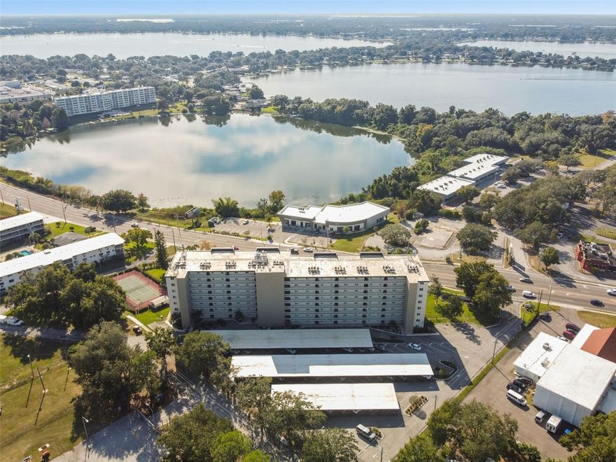 Enjoy effortless living in this beautifully furnished and updated condo perched on the 8th floor, offering breathtaking views of Spring Lake. This spacious residence features 2 bedrooms and 2 bathrooms, including a master suite with a walk-in closet and private bath. The custom kitchen is a standout with granite countertops, wainscoting ceiling, and a convenient bar, complemented by updated appliances and a new LG washer/dryer tower. Flooring includes ceramic tile, laminate, and cozy carpet in the bedrooms, while new windows with motion solar shades bring in natural light and comfort. Located in a desirable 55+ gated community, residents enjoy resort-style amenities including a heated pool, tennis courts, shuffleboard, and a welcoming social room with kitchen. Additional conveniences include 2 elevators, a covered parking space, and monthly fees that cover water, cable, internet, and community amenities.