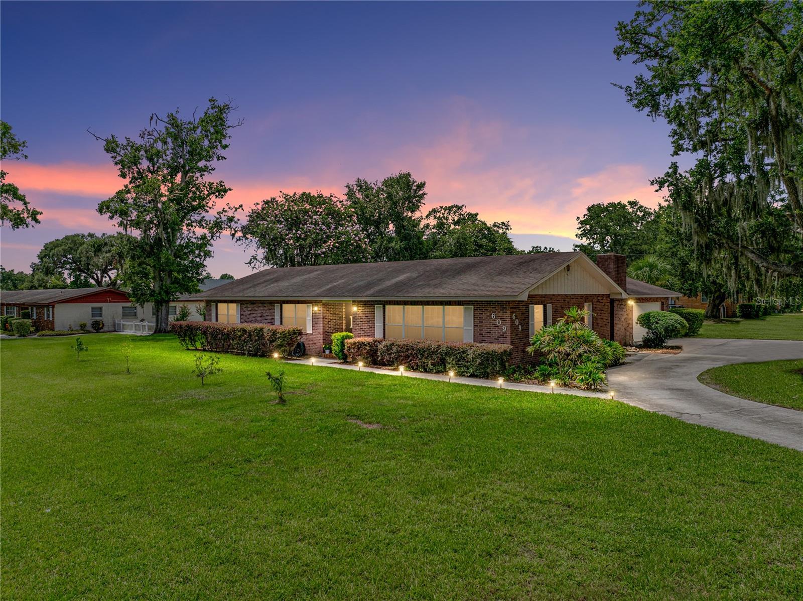 Location, Location, Location is it for this 3BR/2BA pool home situated on an over half acre corner lot. Upon entering, you will find newer wood-look, vinyl flooring throughout the Kitchen, Dining room, hall, and guest bath. To the immediate right, through french doors, you will find a quite spacious Kitchen and Dining room accented with wood beams. Showcasing the Kitchen are 2 year old stainless appliances, granite counters, an island with additional storage, and eat-in space. The Dining room is equally generous in size makes for a cozy family gathering place. To the left of entry, you will find a hall leading to a full guest bathroom as well as two secondary bedrooms, both with walk-in closets. You will also find the Primary bedroom boasting an En Suite bathroom with a fully tiled walk-in shower. The primary bedroom has sliders that lead you out to the enclosed patio. Moving further into the home, you enter the Living room with built-in features, a fireplace, wood beam ceiling accents, a pass-thru window from the Kitchen, and sliders to the enclosed patio. In the Living room you will start to envision relaxing evenings at home or those fun game nights with friends. The Patio and Pool area can be your oasis! Enjoy your morning coffee watching the sunrise or evening cocktail during sunset. Additional upgrades include a new fan and UV lights in the air handler, pool cage added last 18 months, pool pump within last 2 years, and all cabinets in Kitchen and bathrooms are soft close. This charmer is close to shopping, travel, dining, and entertainment. Schedule an appointment today!