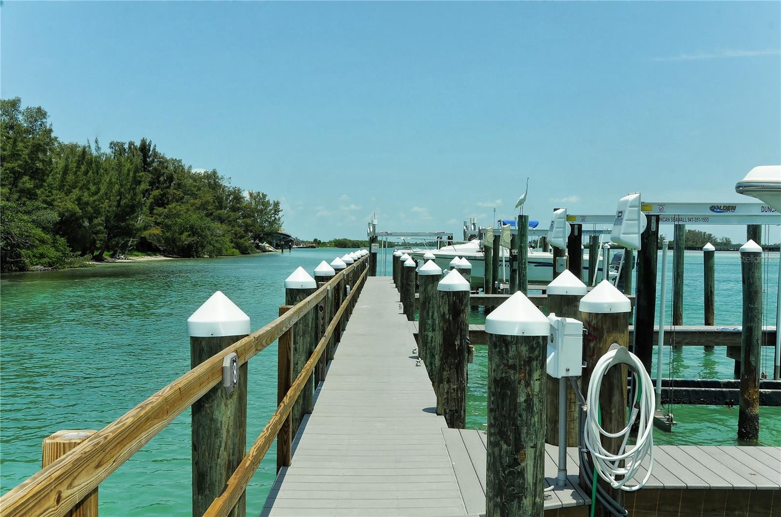 Boca Grande North Marina – Deeded Boat Slip #5
at Boca Grande North Marina is the ideal place to keep your boat on beautiful Gasparilla Island. Located within the private, gated community of Boca Grande North, this is a true boater's paradise.
This fully deeded deepwater slip features a 10,000-pound boat lift with a brand new cable and motor, plus electric, water, and a fish cleaning station right at the slip. The dock has been recently rebuilt with composite materials for low maintenance, following repairs after Hurricane Milton, ensuring long-term durability and peace of mind.
No fixed bridges and deep water make this an exceptional setting—just minutes to the Intracoastal Waterway and the Gulf of Mexico. Whether you're fishing the backwaters or cruising to the Gulf, this location offers unmatched convenience.
Ownership is not contingent on living in the community, so you do not need to be a condo owner to purchase. If you're looking for the perfect base to enjoy the Southwest Florida boating lifestyle, Slip #5 delivers.
