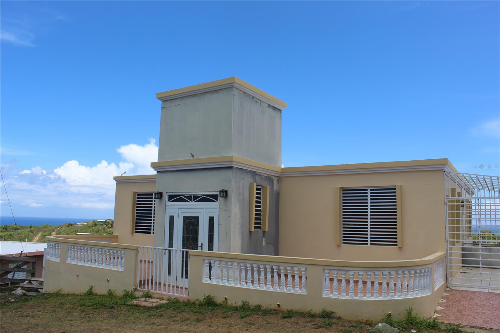 South Wind is a newer duplex home located in the Monte Carmelo sector of Vieques Island with sweeping views of the Southern Coast of Vieques including Esperanza and the islas as well as views of the rompeolas, Vieques' North Coast and the main island of Puerto Rico.
The upstairs is complete and move in ready with a master bedroom that has an en suite. There are two more bedrooms sharing a bathroom. The center portion of the house is very open with high ceilings and includes the living room and the dining room. The kitchen has is contemporary with
white appliances and a laundry closet. From the open living area there is a balcony that extends to the width of the home and offers sweeping views of the Vieques coastline, the island of St Croix on clear days and nights and views to the North shore and Puerto Rico.
The lower level of the home is the second 1/2 of the duplex offering a master bedroom with an en suite and two additional bedrooms sharing a bathroom. The living and kitchen location are set up for a great room situation. The kitchen has not been built however the plumbing and electric are roughed in. There is an additional room that could serve as a dining room, office or an additional bedroom. There is a laundry that can be reached from outside or from within the house.
South Wind represents an excellent value with the opportunity to live in one level while renting