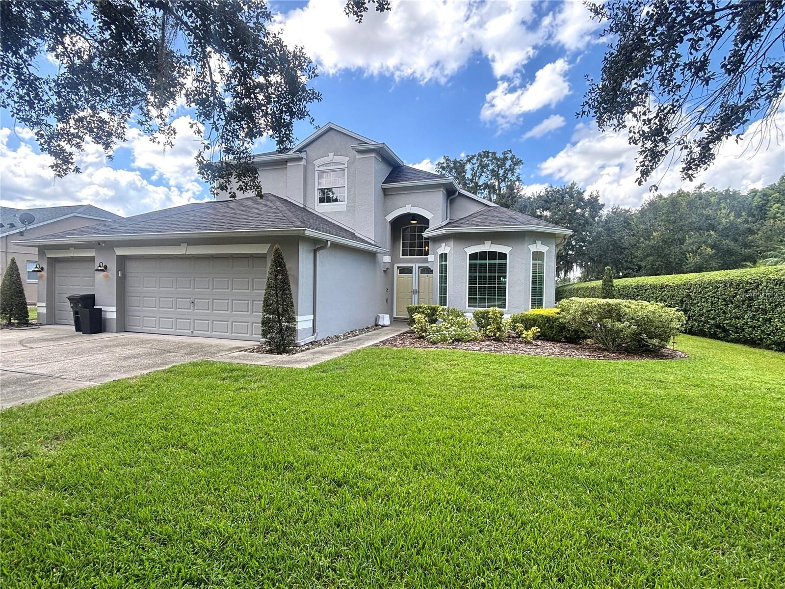Enjoy lakefront living in this beautiful two-story home set within a desirable gated community. Situated on nearly half an acre with generous lake frontage, the property offers stunning sunset views and direct access for small watercraft such as kayaks, canoes, or paddle boards. The open floor plan with vaulted ceilings is ideal for family living and entertaining, featuring a primary suite on the main level, three additional bedrooms upstairs, and a versatile flex space that can easily serve as a fifth bedroom. A spacious three-car garage provides plenty of room for vehicles, storage, or even a boat, while a full irrigation system maintains the grounds. The community also includes a playground and is conveniently located near shopping, dining, and major highways, making this home the perfect blend of comfort, convenience, and waterfront charm. Act now! This one won't last long! All applicants are required to do a credit and background check. Renters insurance is required.