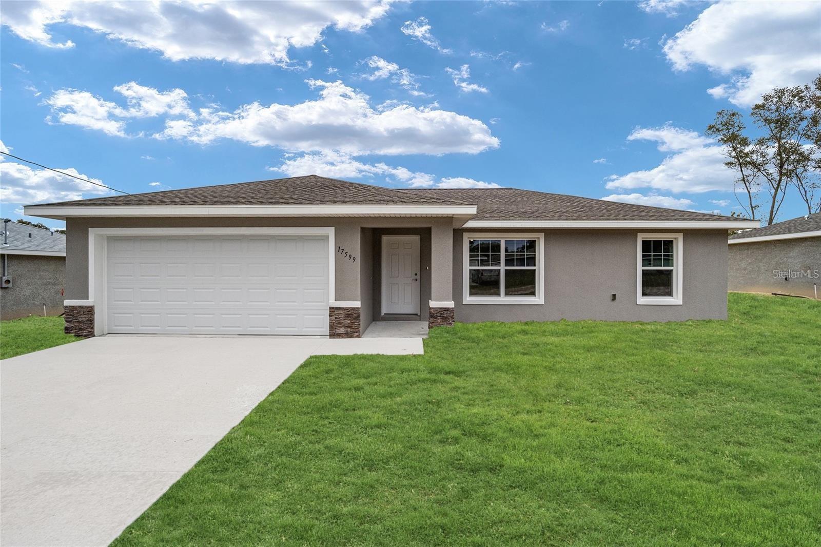 One or more photo(s) has been virtually staged. Welcome home! This brand-new construction is situated in the highly sought-after Lake Weir Gardens, right on a paved road. Conveniently located between Ocala and The Villages with very close commute to 4841. Builder warranty included! Featuring attractive colors throughout, vinyl plank flooring in every room, and beautiful granite countertops. This home is COMPLETE and ready for you to start your new chapter and experience the Florida lifestyle!