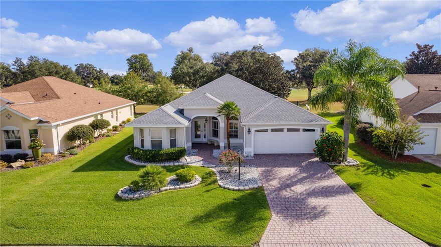 This impeccable residence is the one you've been eagerly awaiting! Nestled within the serene beauty of the Nancy Lopez Championship GOLF COURSE, this exquisite home is the popular GARDENIA model and is ready for you to move in!  Notably, it's TURN-KEY and has NO BOND attached! The owner is an Interior Designer and ALL of the high-end FURNITURE is included!  And to sweeten the deal, the GOLF CART is included as well! What's more, the ROOF, AC, HOT WATER HEATER, and GARAGE DOOR/OPENER have all been replaced just TWO YEARS AGO.

The interior is adorned with fresh paint, showcasing meticulous maintenance and a multitude of tasteful upgrades. You'll immediately notice refined touches such as rounded wall corners, extensive CROWN MOLDING, PLANTATION SHUTTERS throughout, and a flooring selection that excludes carpet in favor of elegant tile, wood, and laminate (NO CARPET). The ceiling and garage walls feature a knock-down finish, adding to the overall polished aesthetic.

Step through the glass front door, and you'll be greeted by the inviting kitchen and a splendid view of the spacious, SCREENED LANAI that OVERLOOKS TORRI PINES #3. The kitchen has undergone a complete transformation, featuring NEWER APPLIANCES, cabinets, and upgraded QUARTZ COUNTERTOPS. The OPEN FLOOR PLAN seamlessly connects the kitchen to the dining room, adorned with chair-rail molding and wainscoting, as well as the comfortable living area.

The laundry room is close to the primary bedroom, which itself exudes a cozy atmosphere with a hand-stenciled focal wall and tasteful furnishings. The ensuite bathroom is a true gem, offering TWO SEPARATE WALK-IN CLOSETS, a sizable linen closet, and a DOUBLE VANITY with upgraded QUARTZ countertops. The frameless shower and separate water closet complete this luxurious space.

The guest wing, located on the opposite side of the house near the entrance, ensures privacy and ample space for your guests. Two comfortably furnished guest rooms await, one without a closet, making them versatile spaces that could serve as additional bedrooms, an office, or even a workout area. The guest bath is conveniently situated between these two rooms.

The outdoor area is expansive, accessible through charming FRENCH DOORS which lead to a large lanai. The stunning view faces East so you can entertain all evening and it doesn't get so hot. Part of the lanai is sheltered, and an attached BIRD CAGE, featuring ALL-NEW SCREENING, allows you to bask in the weather and the stunning view. Entertaining is a breeze with plenty of seating and a FIRE PIT table to gather around. The golf cart path is on the other side of the course, ensuring a peaceful environment with no noise or distractions. To the left, you'll appreciate a PARTIAL WATER VIEW, adding to the overall charm of this beautiful home. 

In addition to all of this is convenience!  You are a short golf cart ride away from groceries, gas, medical offices, two entertainment squares (Spanish Springs and Lake Sumter Landing) and restaurants! Two recreation centers are very close including the First Responders Rec. Center built in 2022 which has a resort style pool and Mulberry Regional Rec Center with 10 pickleball courts!  You're surrounded by two championship golf courses and four executive courses. And you are a quick exit from The Villages for shopping and eating.   Move in and embrace the Villager lifestyle right away in this exceptional residence.