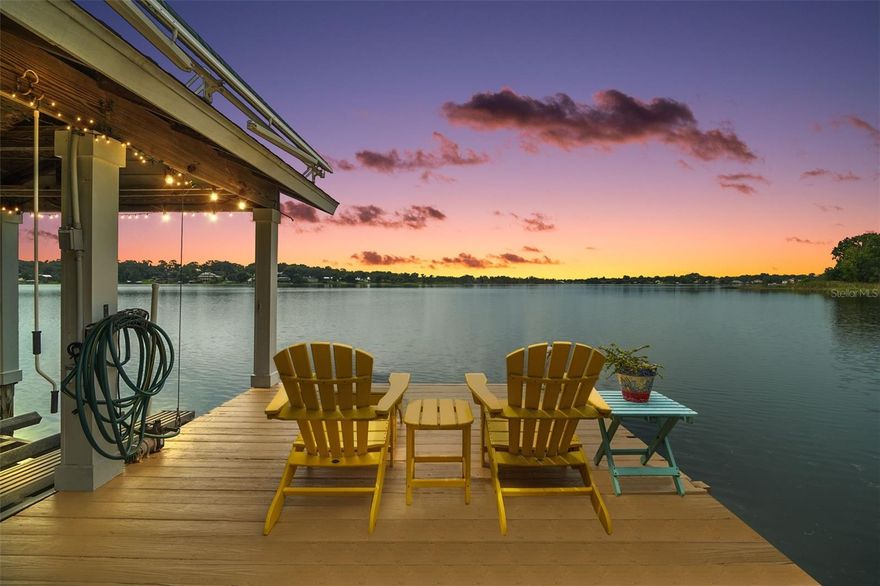 LAKEFRONT MOUNT DORA! SOPHISTICATED HOME ON SPRING FED LAKE GERTRUDE. This custom-built luxury home offering 4 bedrooms, 3½ baths, and approximately 3,364 sq ft of refined living space is on a generous 0.84 acre lot.
Poised majestically on a hillside overlooking coveted Lake Gertrude, this exquisite property provides lakefront living at its finest with 100 +/- feet of waterfront, complete with a private beach, covered boat dock and sun deck, powered boat lift and retractable awning —perfect for lakeside recreation and entertaining!
Designed by renowned local builder Sam Sadler in 2000, the home remains in near-new condition and features timeless architectural elegance. 
 ?The front entrance features a welcoming brick staircase and covered porch with French-style double doors. Mature landscaping, stone pavers, and a concrete walkway enhance the curb appeal. Step into the Florida Room offering breathtaking elevated lake views. The bright, open living room boasts wood floors, cathedral ceilings, intricate millwork, bookshelves, a wood-paneled gas remote fireplace, with built-in entertainment components and classic crown molding. 
The chef’s kitchen & eat in area, also with lake views, features custom cabinetry, granite countertops, a breakfast bar, center island, built-in appliances, ceramic cooktop, and ample pantry storage, with easy flow to the formal dining area, laundry room and convenient half bath.
The primary suite offers peaceful lake views and a spa-inspired bath with garden whirlpool tub, frameless glass shower, dual vanities, private water closet with backyard access, and a spacious walk-in closet. The second guest suite features its own bath with stained-glass skylight and artisan Kohler fixtures, while the third bedroom—accessed through French doors—serves beautifully as a home office or studio.
A covered breezeway connects to the 720 sq. ft. detached two-car garage with workshop space and a private guest suite above with full bath—ideal for extended stays or a retreat.
 
The layout includes a gracious circular driveway in the front with plenty of parking and wooden deck area overlooking the lake, complemented by convenient rear access from Highview Road. The private backyard area offers beautiful landscaping and patio with plenty of entertaining space and room for a pool. 
Additional highlights include new roof and gutters with LeafGuard  (April 2022), upgraded water heaters (2018, 2019), modern HVAC systems (main Lennox in 2015, Fujitsu split for garage suite in 2016, Trane in the master suite 2023), a year-long American Home Shield warranty, a RainBird sprinkler system using lake water, SimpliSafe alarm system, central vacuum system, and a whole-house propane generator- 120 gallon LP tank (owned), built in floor safe
Ideally located, this home is just minutes from Mount Dora’s vibrant downtown with its historic galleries, boutique shops, fine dining, parks, and year-round festivals—easily reached by stroll, bike, or golf cart. You’ll also enjoy an easy commute to Orlando International Airport, the Atlantic beaches, shopping, theme parks, and more. This residence beautifully combines modern luxury with the relaxed elegance of true lakefront living. Furnishings and golf cart are negotiable.