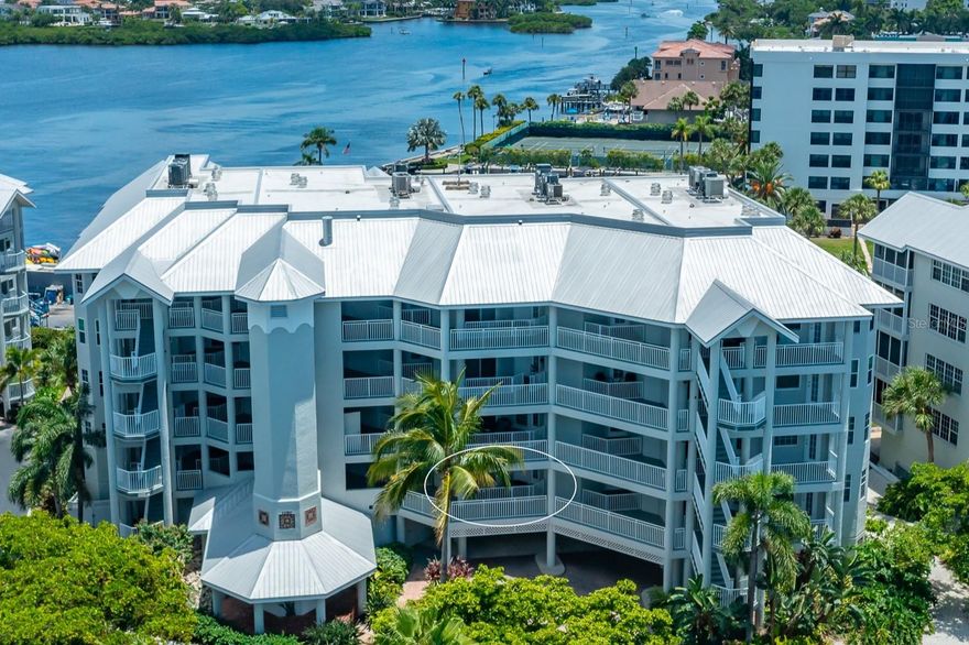 Breathtaking bay views! The expansive 2-bedroom, 2-bath residence boasts an impressive 1,915 square feet of under-air living space, complemented with covered lanais in both front and back and a convenient sunning deck. The interior features both a living room and a family room, a split bedroom plan with ensuites, and hard surface flooring throughout. HVAC and hot water heater replaced in 2024. Rare to properties on the key, there is also a private one-car garage under the building, supplemented by ample open parking. Just a short walk to the public beach, Dolphin Bay offers an array of amenities, including a clubhouse, pool, spa, tennis courts, fitness center and day dock. This gated, pet-friendly community is ideal for those seeking an active waterfront lifestyle in a social and vibrant environment. Take advantage of the trolley stop located right out front, providing easy access to live entertainment and dining options throughout Siesta Key. With exterior painting and elevator renovations complete, now is the time to live your best life at Dolphin Bay!