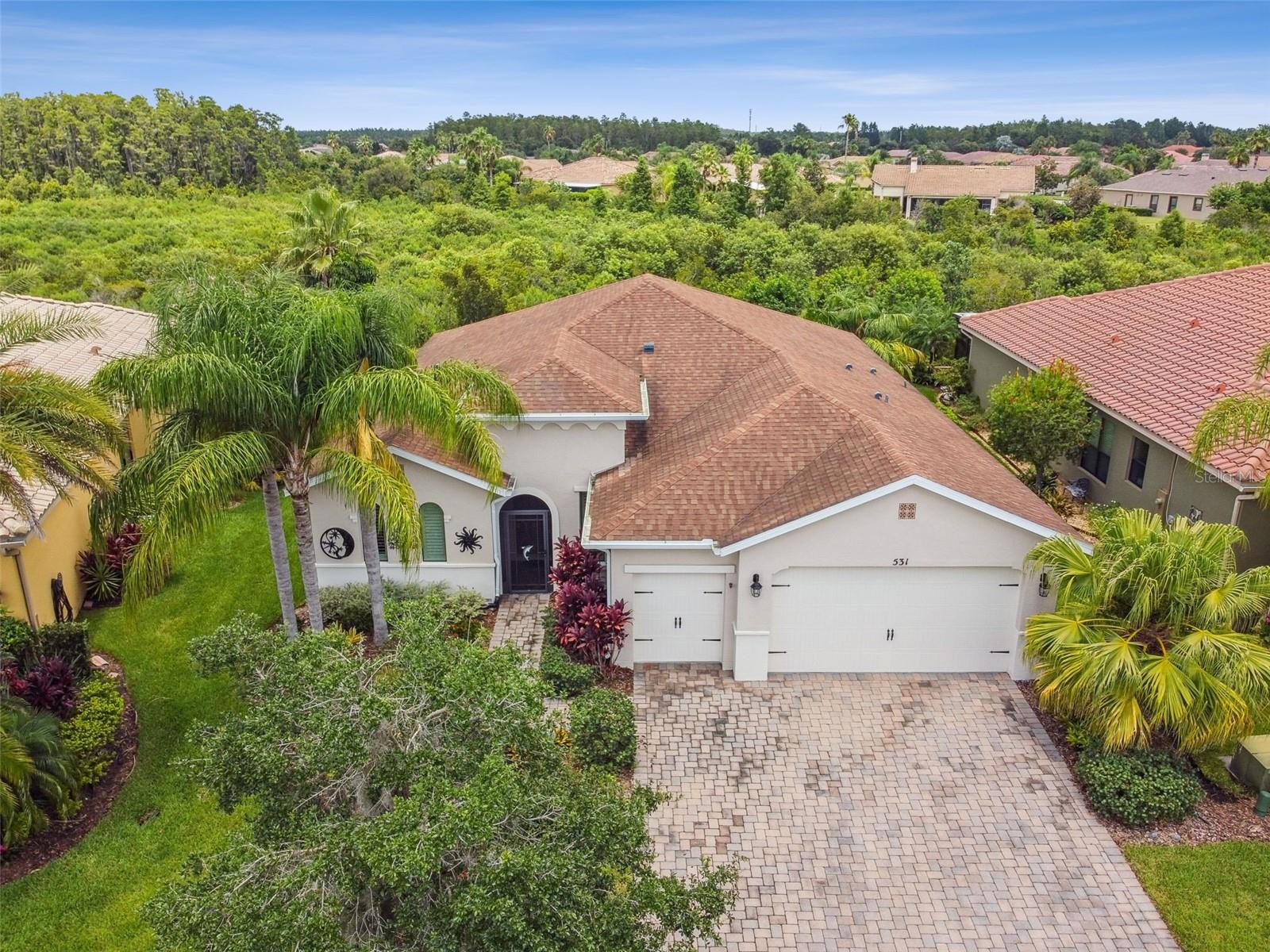 Welcome to this beautifully maintained 2013 Jacksonville model, ideally situated on a deep conservation lot in a quiet neighborhood just moments from the Palms Resort Amenities Center. This 3-bedroom, 3-bath home includes a 2-car garage plus a separate golf cart garage —perfect for Florida living! Step through the screened entryway into a spacious open-concept great room offering serene conservation views. This home features NO carpet—enjoy stylish ceramic tile and luxury vinyl plank flooring throughout. The chef’s kitchen is a dream with an eat-at bar, abundant counter space, and ample cabinetry, ideal for entertaining or everyday living. Two large primary bedroom suites each feature walk-in closets, en-suite bathrooms, and beautiful conservation views for the ultimate in privacy and comfort. Use the flex room as a formal dining area, home office, or study to suit your lifestyle needs. Step outside to the large covered and screened lanai—your perfect spot to relax and enjoy peaceful nature views. The backyard is spacious enough to accommodate a pool or to fence for your pets. Additional highlights include: Upgraded, HOA maintained lush landscaping with irrigation included. Double-pane windows and sliders for energy efficiency Generous garage and storage space, including dedicated golf cart garage. Don’t miss the opportunity to own this exceptional home in a premium location! Solivita is renowned for its vibrant 55+ community, offering an array of activities and amenities tailored to active adults. Whether you’re enjoying a round of golf, engaging in fitness classes, or simply strolling along scenic walking paths, this neighborhood promotes an active and fulfilling lifestyle with over 200 clubs, sports, and activities to choose from. Enjoy the community’s clubhouse, softball field, 14 swimming pools, an indoor walking track, and much more. Every day offers something new to explore and enjoy! This home also features easy access to nearby shops, dining, and health care, offering the perfect balance of privacy and lifestyle.