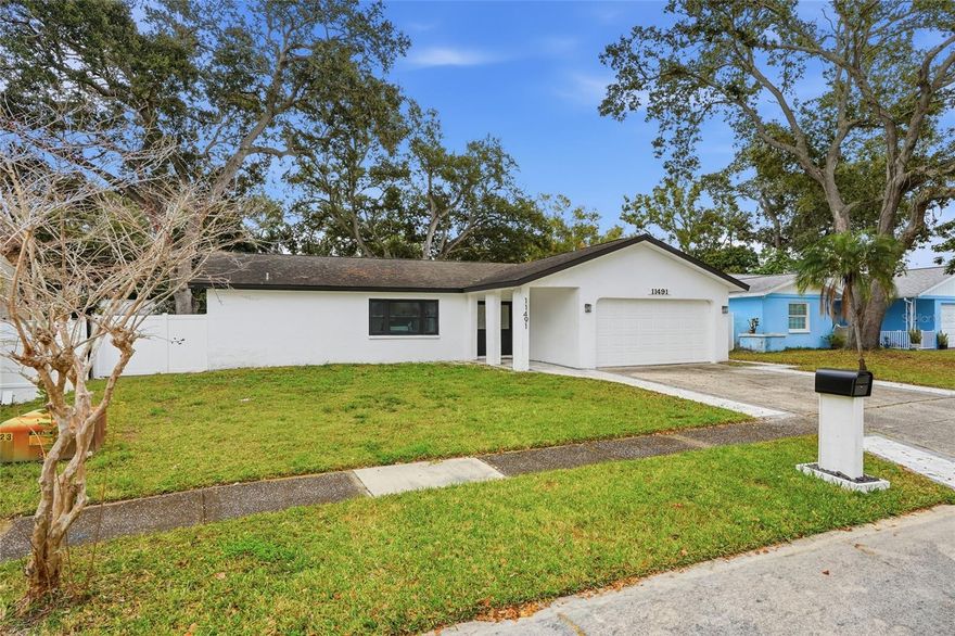 This nearly 2,000 SqFt move-in ready home with OFFICE, BONUS ROOM or 4th Bedroom -PLUS- fully enclosed SUNROOM is located in a popular centrally located Pinellas Park community. Best of all is the NEW ROOF and double pane STORM WINDOWS and SLIDERS throughout! The open and split floor plan is the perfect layout for everyday living or for entertaining your family and friends, invite them all! The new kitchen is the true focal point, featuring a massive center island with additional seating, sleek stunning quartz countertops, new cabinetry and luxury built-in stove, cooktop and built-in microwave. The open kitchen leads to the grand living room and dining room which both allow plenty of room for large furnishings and decor. At the back of the home is a large bonus room with sliders to the back patio that can easily serve as a quiet HOME OFFICE, GYM, PLAYROOM, GAME ROOM or whatever your heart desires. The oversized FULLY ENCLOSED FLORIDA ROOM adds even more usable living space and features a WET BAR and built-in cabinetry. Step outside the sliding glass doors to your expansive fenced in backyard which offers privacy and shade with mature trees and a spacious paved patio. There’s plenty of room for your favorite patio furniture, lounge chairs and of course the BBQ! This most desirable SPLIT FLOOR PLAN plan offers tons of space and privacy, and the beautifully designed BATHROOMS are decked out with modern fixtures and finishes. Another convenience is your large laundry room with washer, dryer and utility sink which then leads to the spacious 2 car garage. Move-in ready and peace of mind are already in place here with the storm windows, new roof, and an AC system that has been well maintained and recently serviced. Location, Location, Location! This home offers quick access to everything - just minutes from restaurants, shopping, parks, grocery stores, Park Place Center (Target, movies), Freedom Lake Park (trails and dog park), easy and quick access to the bridges connecting Tampa, and a short drive to downtown St. Pete and the World-renowned Gulf beaches. Don’t miss out on this one, schedule your showing today!