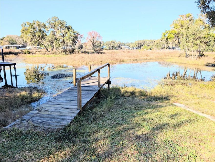 WATERFRONT! FURNISHED! WOW LOOK AT THIS GREAT LAKE HOME PROPERTY ON .42 OF AN ACRE. 2-bedroom, 1.5-bathroom mobile home with a beautiful view, New Air Conditioner heat pump in December of 2023, roof resealed and fascia boards in June of 2023, New nylon threaded vapor barrier in December 2016, Large side patio (That could be screened in) to sit out on and enjoy your morning coffee watching the sunrise or unwind at the end of the day capturing the most beautiful sunsets and listening to all of nature's wonders! Just 1.5 miles from Hernando Boat Ramp and Hernando Beach. dock, boat ramp, fire pit, 3 sheds, Side patio, 2 covered carports, washer and dryer, access to the Tsala Apopka chain of lakes in Hernando. 
Close