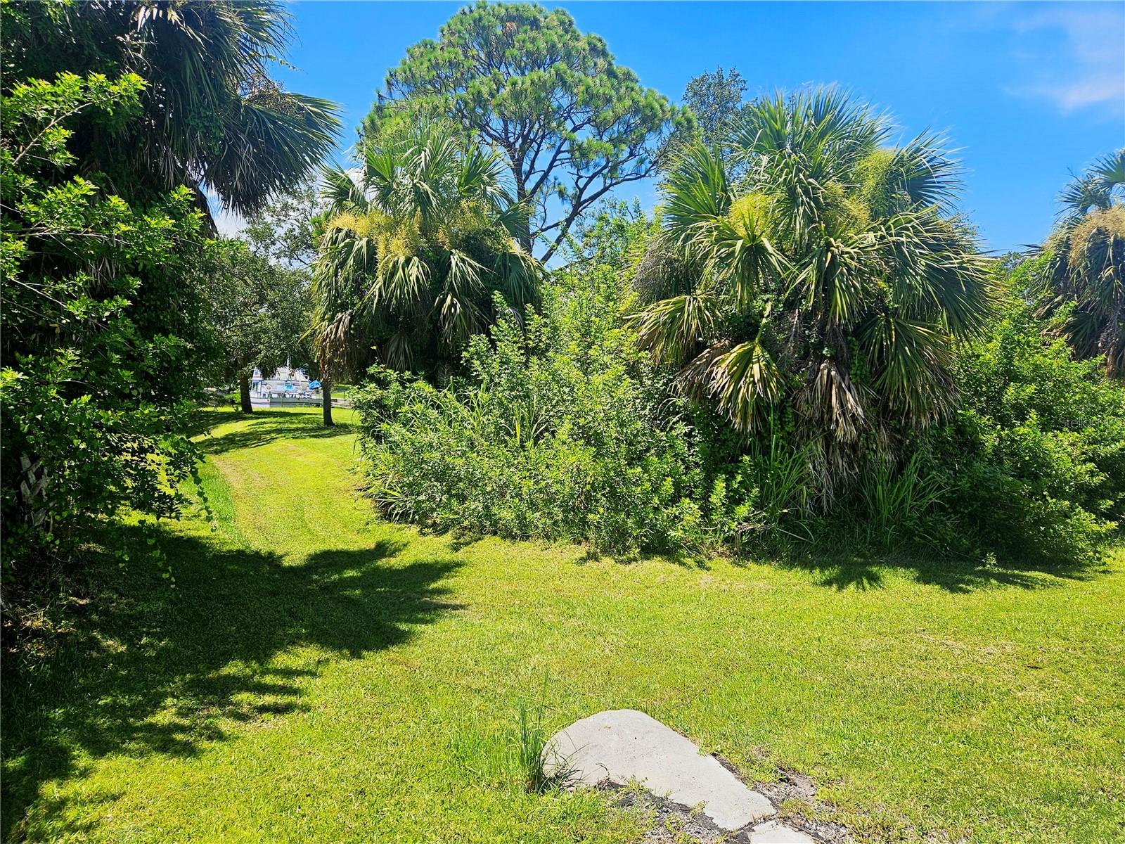 Don't let the front of the property fool you! Behind the brush lies a beautiful lot waiting for your new home.
Discover the unparalleled potential of this exceptional vacant lot near the heart of Port Charlotte. Boasting approximately 40 feet of saltwater canal frontage on the serene Manchester Waterway, this property offers direct access to Charlotte Harbor and the Gulf with one bridge before getting there, making it an idyllic setting for boating and fishing enthusiasts.
Imagine building your dream home and enjoying breathtaking sunsets and expansive canal views from your very own backyard. This residential lot is situated in a neighborhood with public water and sewer available, providing a seamless building experience.
Conveniently located, this property is approximately minutes from a wide array of amenities, including restaurants, beaches, and golf. Enjoy easy access to major roadways like US-41 and I75.
Whether you're looking to build your permanent residence, a seasonal escape, or an investment property, this waterfront parcel presents a remarkable opportunity to embrace the Florida lifestyle AND No HOA fees!!