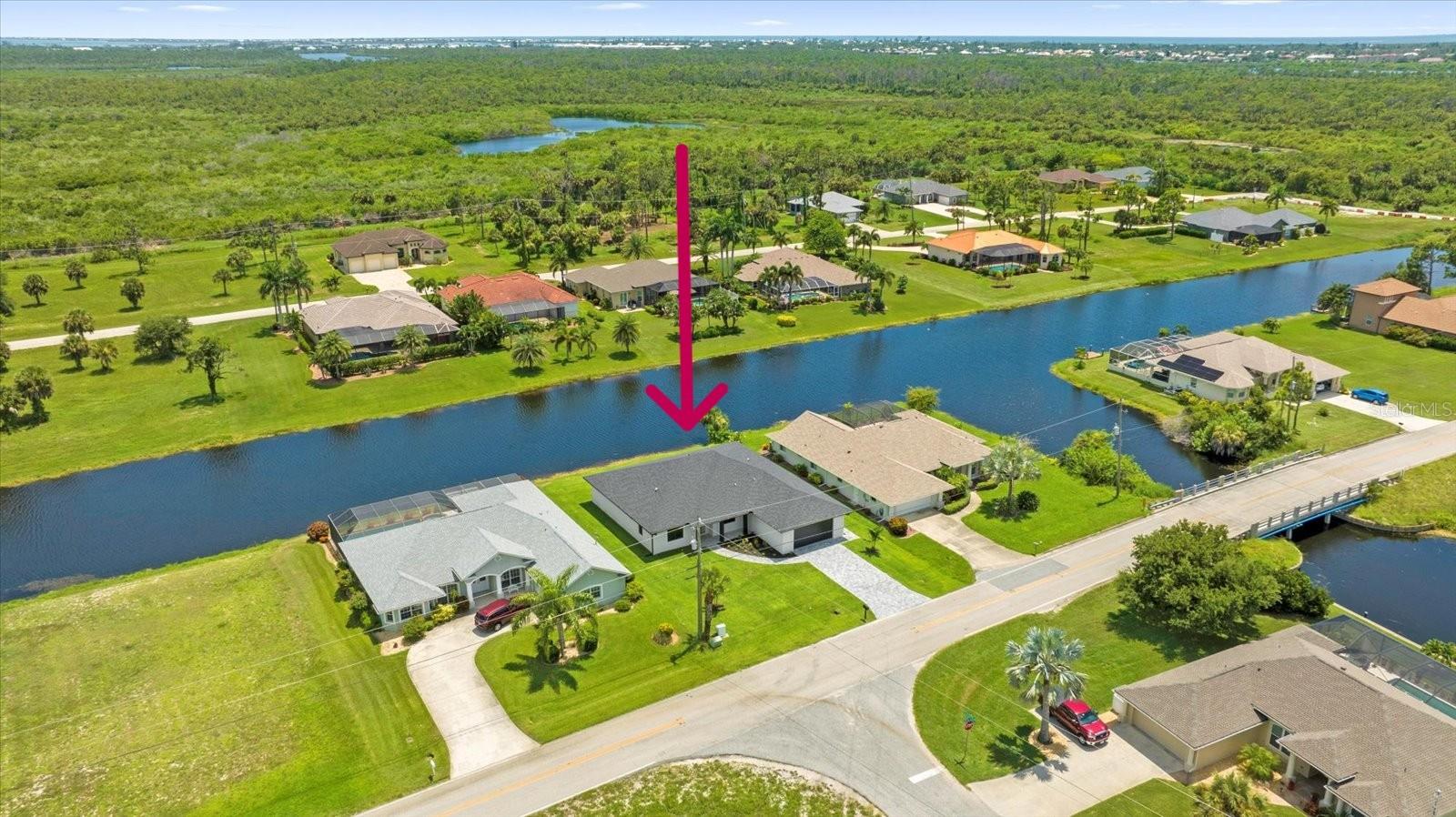 Live the waterfront dream in this brand-new luxury home in Pine Valley, Rotonda West, perfectly positioned along a peaceful canal with stunning water views and just minutes from the stunning Gulf beaches of South West Florida. Featuring 2,486sq ft of sleek modern design, this 4-bedroom, 3-bath home includes a versatile flex room (perfect as a home office or even 5th bedroom), a secondary primary suite and oversized 2-car garage. The showstopping kitchen boasts quartz countertops, a waterfall island, soft-close cabinetry, stainless steel appliances, and a designer backsplash; ideal for everyday living and entertaining. Soaring ceilings, impact-rated windows 8 foot tall doors throughout and an open-concept layout fill the home with natural light. The luxurious primary suite offers dual walk-in closets, a spa-inspired bath with floating vanities, an oversized shower, and a porcelain soaking tub. Enjoy Florida living at its finest with a spacious lanai and direct canal access for boating, bass fishing, or simply relaxing waterside. Thoughtful details, high-end finishes and waterfront living make this modern retreat a must-see! This could also be an amazing AirBnb rental opportunity.