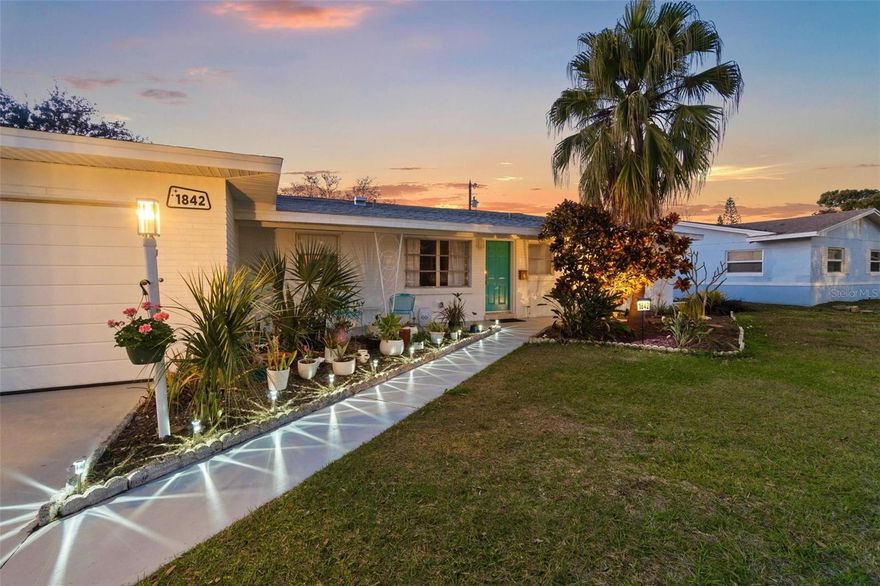 This turnkey Mid-Century Modern gem is a CERTIFIED PRE-OWNED HOME
Complete with a recent full inspection (repairs done!) and a seller-paid 1-Year Home Warranty.

Welcome to our 1959 Atomic Time Capsule concrete block, 3 bed/2 full bath, split floor plan home which has been lovingly restored and upgraded while saving all the charm of mid-century ranch homes of Florida!
 
You will find: coved ceilings, pastel bathrooms with original atomic tiles, original gold flecked Formica in the kitchen, original GE turquoise & chrome wall oven, and don’t forget the fully restored 1959 NuTone combination clock/doorbell above the kitchen sink keeping perfect time again nearly 70 years later!
 
The mid-century design choices that make this home great: the gorgeous & gleaming terrazzo floors along with plaster over thick sheetrock for walls keep the house up to 10 degrees cooler naturally. The original & fully functional zoned radiant heat system throughout the house for when it becomes a little too chilly. Also, the large closets were placed along entire walls so not only do you get great storage, but they are also used as sound barriers between rooms making the living space that much better!
 
Modern features to compliment the original charm include:
new glass paneled Samsung refrigerator and dishwasher which blend perfectly with the original slab-front cabinets and a stainless steel workstation sink in the kitchen, quartz counters in the bathrooms, upgraded lighting throughout the home with sleek ceiling fans in bedrooms and sunroom, and new Sherwin-Williams Emerald-grade paint through most
of the interior and the exterior.
 
On the practical side: new and upgraded electrical panel (2023/2025), new HVAC (2020) which was relocated to the garage side to minimize sound intrusion, a new roof (2023), and a refinished garage (2025) with laundry nook is ready for your appliances. And we can’t forget the new hybrid water heater (2025) in the garage that pulls heat from the air to heat the water, highly practical and energy saving choice for Florida!
 
Smart features: include keyless entry, WiFi enabled garage door opener, dishwasher and refrigerator that can be controlled by an app, an electricity use monitor, and remote controlled fans (some with color changing lights.)
 
The Lay-out: From the front entry your gaze fixes on the spacious backyard through a huge door wall and the 4 season sunroom. The primary suite on the left, includes a bathroom, its own linen closet (accessible from the bathroom, through a little mirrored hatch), and two separate upgraded closets. The suite can be accessed by a pocket door from the dining area or a standard door from the sunroom. To the right of the living space: a large bedroom (potentially a second primary) and a smaller one, with a hall bath. Place a door at the hallway entrance and you could have a ready made in-law suite.

The Yard: The backyard is huge and begs for a swimming pool, a veggie garden and a fire pit. Invasive species of plants & trees have been removed, and edging blocks have been saved, so that you can make the landscape of your vintage “Florida-friendly” dreams!
 
The Furnishings: The house has been staged entirely with vintage furnishings, art, and
housewares which can also be purchased by the new homeowners should they wish!