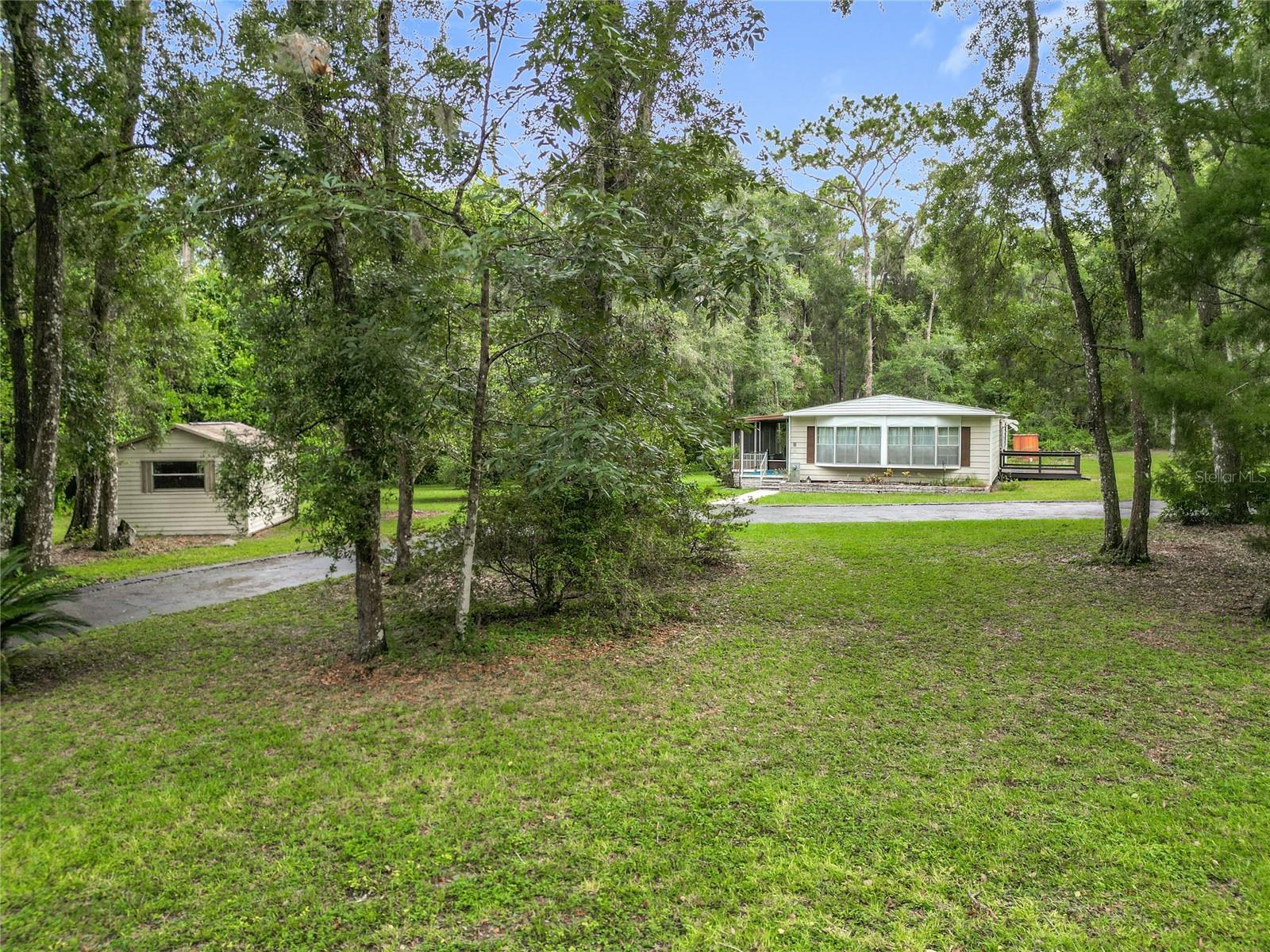Your quiet retreat awaits! This move-in ready doublewide sits on a peaceful 1-acre parcel in Bushnell. Inside, you’ll find a spacious layout with 2 ensuite bedrooms for comfort and privacy. A screened-in porch provides the perfect spot to relax and enjoy the serene surroundings. Major updates include a new roof in 2020 and A/C in 2020. A shed on the property offers additional storage or a place to work on your hobbies. This one won't last long so schedule your appointment today!