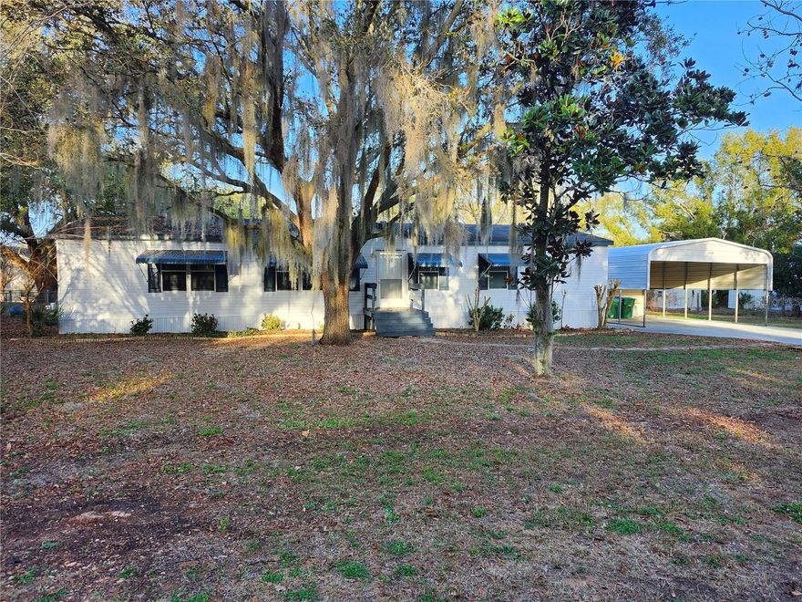 NO HOA - ZERO DOWN USDA Financing eligible: Come see this newly remodeled stunning 3 bed / 2 bath home nestled in quiet, historic town of Monteverde, sitting on an oversized .44 acre lot with 2 large storage sheds (both with electricity), 3 porches and an overly spacious 2 car carport, with room to park your RV in the side yard.  The 2026 renovations include all new flooring, painted entire exterior of home, shed, and carport, painted all interior including ceilings, new stainless appliances, granite countertops in kitchen and both bathrooms, new tiled walk-in shower and reglazed garden tub in the primary bathroom, new toilets, new mini-blinds throughout the entire home, new lighting fixtures in kitchen, dining, and bathrooms, as well as the A/C being replaced in late 2022. This home is move in ready and looks brand new. There are no issues with the roof, but it is the original roof, seller is willing to contribute toward a new roof with a strong buyer offer. The following Community amenities are all walking distance from the home: library, post office, convenience store, ice cream shop, BBQ restaurant, public boat ramp to Lake Apopka, the Town's beautiful walking trail, playground, park, basketball courts, tennis courts, and pickleball courts are all less than a 1/2 mile walk from your front door. All while being a short commute to Orlando and the theme parks.  Don't miss your opportunity to view this delightful home.