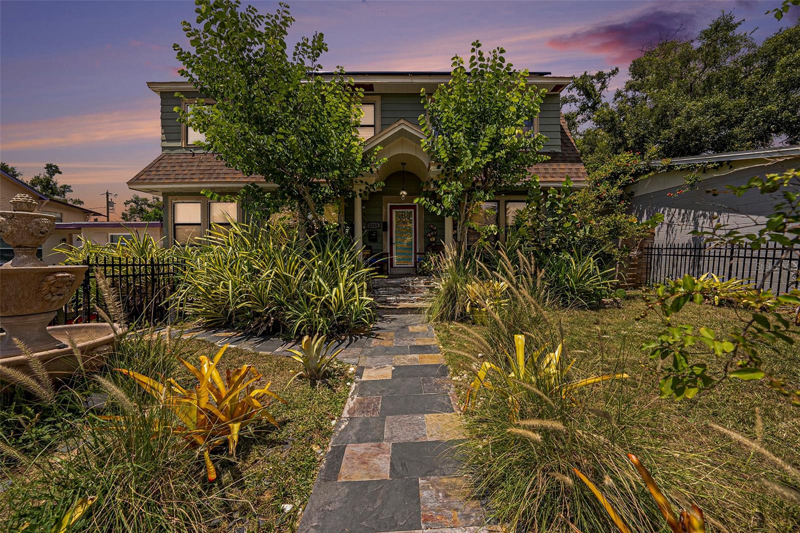 Welcome to 2255 Trelain Dr S! This timeless 1928 two-story Craftsman sits just three doors down from Al Capone’s storied Lake Maggiore residence. Nestled on a quiet, brick-lined street in Lake Maggiore Shores, the 5-bedroom, 2-bath home spans 2,192 sq ft and showcases tile floors, tall ceilings, vintage hardware, and a decorative fireplace.
The flexible floor plan offers space for dual home offices, a nursery, or creative pursuits. The kitchen and baths await your personal design, giving you the chance to blend modern updates with historic character. Energy-conscious buyers will appreciate the paid-off solar panels upon closing, while the accessory dwelling unit (ADU) with loft provides the perfect option for guests, rental income, or studio space. Currently, multiple long-term tenants are in place on month-to-month leases, generating $3,515 in monthly rental income.
Enjoy a landscaped lot with off-street parking and a welcoming front porch, all just blocks from Dell Holmes Park, Lake Maggiore’s trails and splash pad, and less than 10 minutes to Tropicana Field, Central Ave, and vibrant downtown St. Pete. Located in Flood Zone X with no HOA.
Priced under $400/sq ft with million-dollar neighbors nearby, this is a rare opportunity to own a piece of St. Petersburg’s history, enjoy immediate rental income, and build lasting equity in one of the city’s most appreciating neighborhoods.