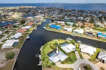 Welcome to 131 Casa Lane, a rare Punta Gorda Isles waterfront gem offering 163 feet of premium sailboat-access canal frontage and a boater’s paradise! Situated on a coveted corner lot in a No Wake Zone, this property provides full Gulf access with no fixed bridges, allowing quick, unobstructed navigation to Charlotte Harbor and beyond.
Enjoy two docks including a concrete open dock, floating Sea-Doo docks, a powered boat lift, and a kayak lift—perfect for all your watercraft. The wrap-around seawall creates generous space for entertaining, fishing, or simply soaking in stunning water views.
Inside, the home’s open layout connects to an expansive screened lanai and a 30×15 ft heated, saltwater pool, creating the ultimate Florida indoor-outdoor lifestyle. Whether you’re hosting friends, enjoying a quiet sunset cruise, or paddling out for a morning adventure, this home is designed for relaxed waterfront living.
Located just minutes from Fishermen’s Village, downtown Punta Gorda dining, shopping, and parks, 131 Casa Lane offers the best of coastal living with quick access to amenities.
Don’t miss this unique opportunity—properties with this level of water frontage, dock capacity, and Gulf access are a rare find in Punta Gorda Isles! This property is currently being used as a VRBO/Airbnb income producing / business opportunity.