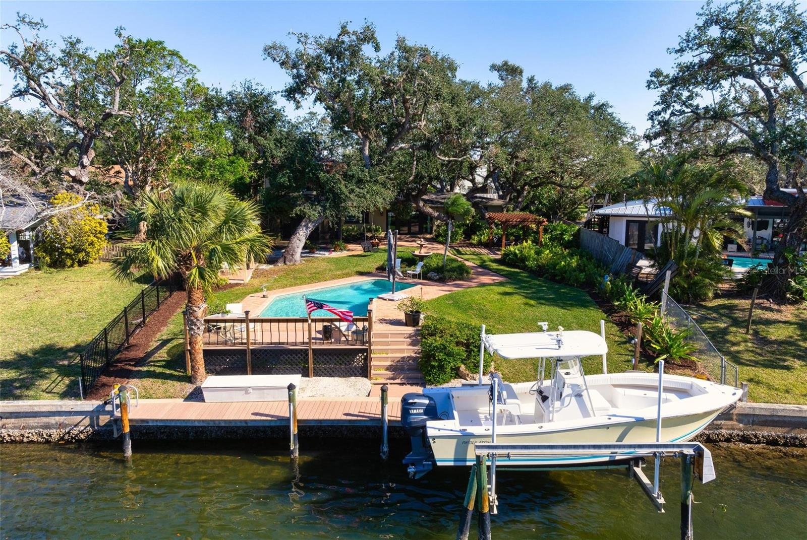 Spectacular waterfront property nestled W of the Trail off of Stickney Point and 41. This fabulous completely updated "Old Florida" gem offers Florida coastal living at it's best with the backyard on the "Y" intersection of two canals. Boaters and lovers of nature will enjoy this mature oak tree laden lot that has been professionally landscaped. It is a quick boat or kayak ride, walk or drive to world famous Siesta Key with it's ever-glistening sand. Concrete, lighted pillars guide you to the driveway with custom designed pavers. The magnificent glass hurricane impact front door leads to an open floor plan boasting distinctive terrazzo floors and light from spacious impact windows throughout. The rear french doors offer spectacular views of 126 feet of garden, fountains, open private pool and water surrounded by Chicago Brick. These french doors include sliding screens that close for terrific cross ventilation throughout this home. They will lead you to the delightful large trex deck (cool deck) with breezes and views galore, room for a dinner party of 12. Step down to the 45 foot dock with fish stand and 10,000 lb. lighted boat lift. Backyard features several seating areas including a pergola with Chicago Brick and a covered cabana for grilling/lounging with lovely views of the pool and water leading directly to the ICW which is minutes away. The kitchen features quartz counters, wooden shaker cabinetry to the ceiling, updated stainless steel appliances. reverse osmosis with minerals, push button disposal and views of backyard activity through the double windows. It effortlessly flows through to the living and dining room creating an ideal space for indoor entertaining. Enter the separate family room with travertine floors and french doors leading to a newly screened in lanai with side wall fan. Two guest rooms, one with a Murphy bed, open to a newly renovated full bath on main floor. Retreat upstairs to the second floor primary suite, with fantastic water views from every direction, hardwood floors and impact French doors with retractible screens for cross ventilation. Window treatments include Hunter Douglas blackout shades. You will love the private balcony for its spectacular sunsets, moon rises, and your morning coffee. The adjoining bathroom features separate double sinks and two large custom walk-in closets. Enjoy the large Carrera tiled walk-in shower with its marble seat and niches. Throughout you will find custom wooden plantation shutters and ceiling fans. This move in ready home is situated in a convenient area of Sarasota, close to Siesta Key, cultural events downtown, opera, ballet, arts, shopping and all of the vibrant events happening along the west coast. Sarasota’s small town feel combines with a big city lifestyle. This home is truly it’s own little piece of paradise. The newly opened Midnight Pass beckons you to the waters of the Gulf of Mexico. Come fish off the dock at 1827.
***NO DAMAGE FROM HURRICANES DEBBIE, HELENE OR MILTON*** HOUSE IS NOT LOCATED IN A FLOOD ZONE. (zone X)