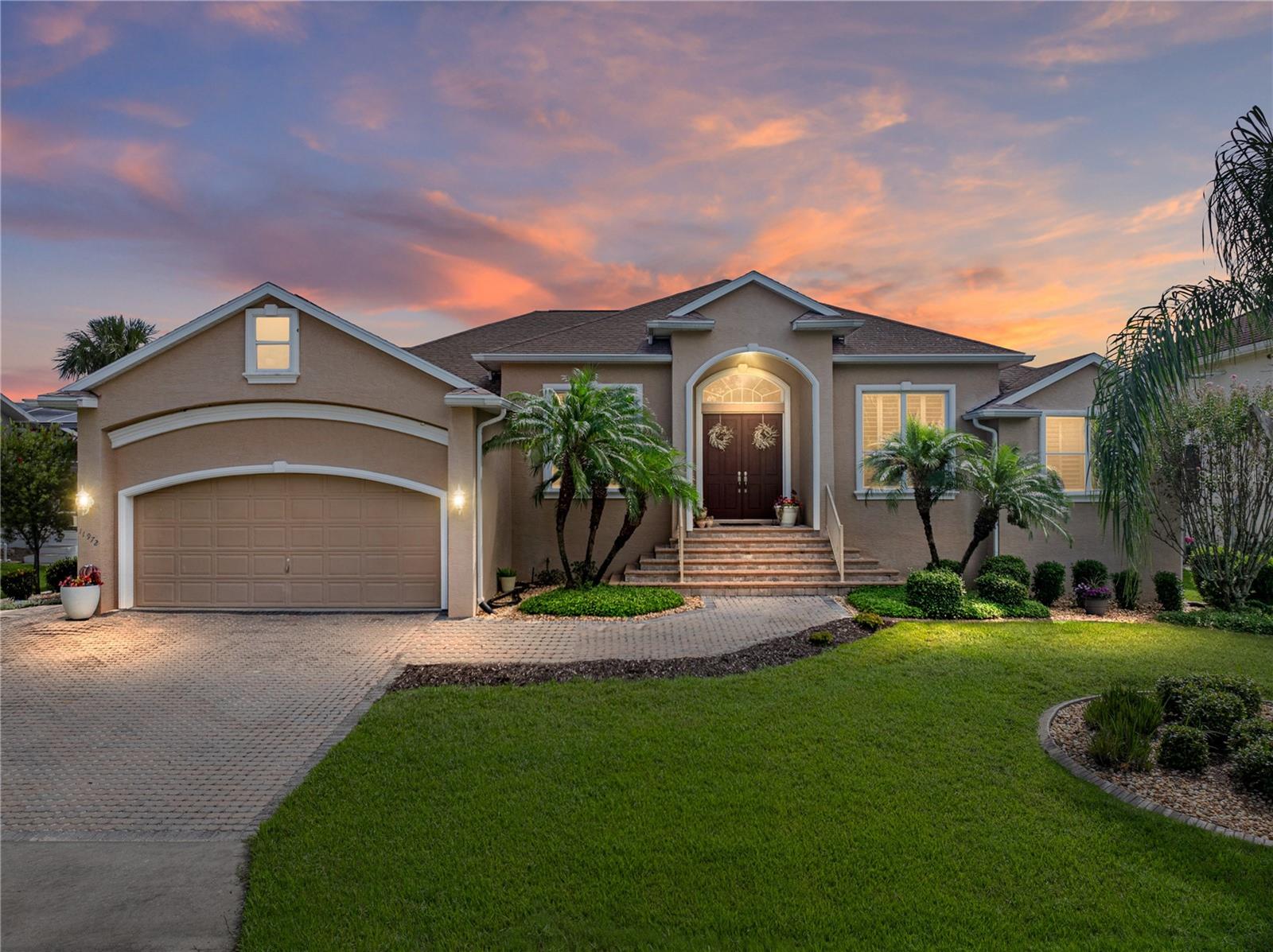 Discover this custom-built Joe Flynn residence offering timeless craftsmanship and modern updates, perfectly positioned with direct access to the Homosassa River and Gulf of Mexico. Built in 2007 on an engineered foundation with 67 pilings, this 3-bedroom, 3-bath, plus office, single-story home spans 3,281 sq. ft. and combines elegance with durability.
Step through the double-door entry into a freshly painted interior enhanced by plantation shutters, coffered ceilings, arched doorways, crown molding, and 6-panel doors. Every bedroom features a walk-in closet with built-in organizers, and each bath offers generous linen storage and corian countertops. The office showcases floor-to-ceiling built-ins, while stained-glass accents in the bathrooms add unique artistry.
The chef’s kitchen impresses with quartz countertops (2021), high-end appliances (2019), a spacious island, and abundant cabinetry. Gather in the Florida room with its indoor grill, bar, sink, and solar shades—perfect for entertaining year-round. A propane fireplace adds warmth and character to the living room.
Recent upgrades include a new A/C (2022), 22kW whole-house generator (2021), fresh paint (2021), and new carpet (2021), ensuring comfort and peace of mind. Technology is integrated throughout with a security system, surround sound, and built-in speakers.
Outdoors, enjoy a two-car garage, with a custom tool bench, 9,000-lb boat lift, brick paver patio, beautiful landscaping ,fish cleaning station and brick fire pit facing the water—an angler’s dream setup.
This waterfront retreat balances luxury, function, and Florida lifestyle living—just a short boat ride away from the Gulf of Mexico.