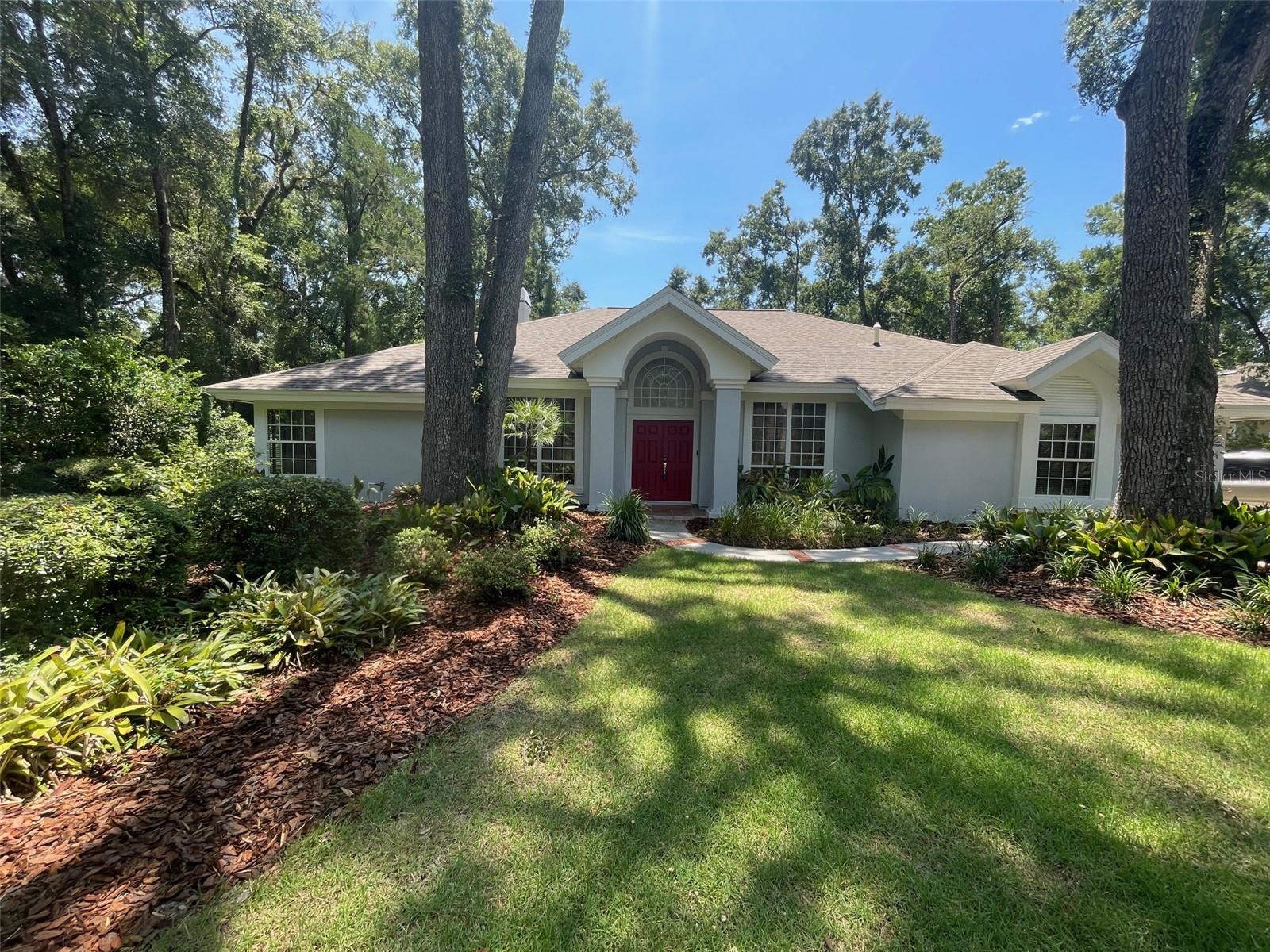 Welcome to this exquisite, custom-built Tom Hunt home, ideally situated on a peaceful cul-de-sac within the highly sought-after Graham's Mill community in Haile Plantation. This stunning property offers four spacious bedrooms and three full bathrooms, providing ample comfort and privacy. You'll love the expansive outdoor living space, featuring a screened pool and a large lanai, perfect for relaxing and entertaining.
This home boasts an exceptional location, placing you just minutes away from the vibrant Haile Village Center, where you can explore a variety of shops and restaurants, or enjoy the lively Saturday Farmer's Market. For those who appreciate an active lifestyle, miles of scenic biking and walking paths wind throughout the neighborhood, offering endless opportunities for outdoor enjoyment. Inside, you'll find a thoughtfully designed layout that includes a separate formal dining room, a gracious formal living room, and a beautifully updated open kitchen with a convenient breakfast nook. The kitchen seamlessly flows into the inviting family room, which features a cozy fireplace and both spaces offer lovely views of the lushly landscaped pool area. The home has been meticulously updated with high-end features such as a six-burner gas stove, a tankless water heater, new flooring in the living areas, Delta water fixtures, a touchless kitchen faucet, a newer pool pump, and a recently renovated pool. These fine details ensure a luxurious and worry-free living experience.
Beyond the fantastic features of the home itself, the property sits on a generously sized lot with fresh, appealing landscaping. Its prime location offers easy access to major Gainesville amenities, including the University of Florida, Butler Plaza, Shands, the VA Hospital, North Florida Regional Medical Center, and Celebration Pointe. You'll also appreciate the convenience of the Haile Market Square, which includes a Publix grocery store, all within the neighborhood. Neighbors benefit from the proximity to two elementary schools and a middle school, making them true neighborhood schools and significantly reducing commute times.