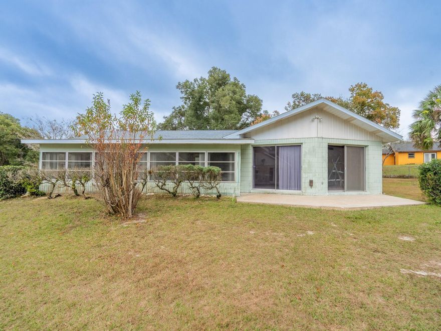 Charming Home on Oversized Lot in a Quiet Cul-de-Sac – 5 Spring Lake Lane, Ocala, FL 34472
2 Bedrooms | 2 Bathrooms | 1,464 Sq Ft | .36 Acre | 2022 Roof | Carport | No HOA

Welcome to this charming, well-maintained home located on a quiet cul-de-sac in Silver Springs Shores. Built in 1970 and resting on an oversized .36-acre lot, this property is full of character and offers comfort, convenience, and the relaxed Florida lifestyle. The roof was updated in 2022, giving buyers peace of mind.

This spacious home offers 2 bedrooms, 2 bathrooms, and 1,464 sq ft of living area. The large living room is a standout feature, showcasing vaulted ceilings with wood beam accents and large sliding doors that lead to a covered back porch—ideal for lounging or entertaining. Flooring consists of laminate in the entry and hallway, tile in the kitchen and baths, and carpet in the main living areas and bedrooms.

The main bedroom is generously sized, with the main bathroom offering a tiled tub/shower combo. The cozy guest bedroom is complemented by a second bathroom with a tiled shower and glass door enclosure. The home is clean and move-in ready, yet offers the opportunity for cosmetic updating to make it uniquely yours.

Additional conveniences include a covered, attached carport, plus an attached laundry room and storage area for added functionality. Outside, the property features a wood storage shed, mature landscaping, and plenty of space to enjoy outdoor living.

Best of all, this home sits minutes from the Silver Springs Community Center, where amenities include a swimming pool, pickleball courts, and a range of recreational programs. You’re also close to local parks, golf courses, dining, and shopping—and only 18 miles from the World Equestrian Center. With no HOA, you’ll enjoy flexibility and freedom. City Water, Marion Utilities, Duke Energy, TICO Gas.

This property blends comfort, location, and potential—schedule your showing today and discover all it has to offer!