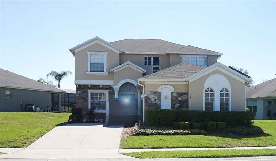 This beautiful 2 story 5 bedroom/4.5 bathroom home sits on the largest lot on the community. Recently upgraded with a hard wood floor, solar panels, new A/C units, 2 year roof. Airy open plan home with well sized kitchen and large first floor master bedroom with en-suite bathroom. Master bedroom opens onto screened-in deck with covered lanai and pool with integrated spa. The remaining 4 bedrooms which includes the 2nd master en-suite are located upstairs. Situated across from the private lake and the clubhouse. This lovely gated community with 24 hour security is conveniently located for access to the attractions, I-4 intersection, supermarkets, banks and schools which makes it an ideal home and location for use as a short term rental vacation home or a permanent residence.