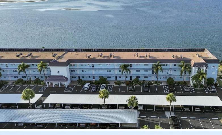 Wake up everyday to the breathtaking views of the open Gulf of Mexico. Feel like you're on vacation every day at this well maintained and friendly adult community (above 55). This spacious 3rd floor one bedroom, 1.5 bathroom gem is designed for comfort with custom wall paper throughout, faux finished painted walls, brand new luxury vinyl tile plank flooring, full kitchen, large walk in closet, plenty of storage (including an external storage closet), a vanity area and den/study room facing the water. Amenities include a resort like built-in pool, large clubhouse with a fitness center, tennis courts, shuffle board courts, a fishing dock and more. Currently there is a bed, futon, entertainment center, dining room set and credenzas, however if you have your own furniture the existing furniture can be removed.