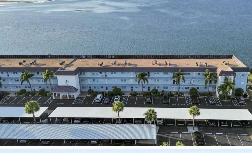 Wake up everyday to the breathtaking views of the open Gulf of Mexico. Feel like you're on vacation every day at this well maintained and friendly adult community (above 55). This spacious 3rd floor one bedroom, 1.5 bathroom gem is designed for comfort with custom wall paper throughout, faux finished painted walls, brand new luxury vinyl tile plank flooring, full kitchen, large walk in closet, plenty of storage (including an external storage closet), a vanity area and den/study room facing the water. Amenities include a resort like built-in pool, large clubhouse with a fitness center, tennis courts, shuffle board courts, a fishing dock and more. Currently there is a bed, futon, entertainment center, dining room set and credenzas, however if you have your own furniture the existing furniture can be removed.
