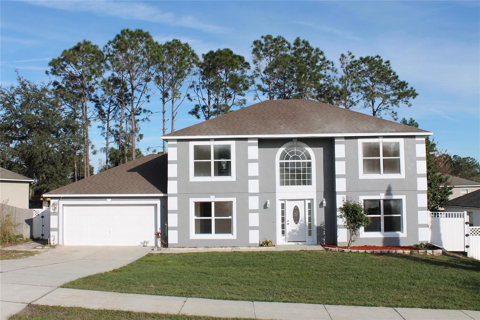 Welcome to your very roomy and inviting 4-bedroom 2.5 bath home in Clermont, FL. Access to walking trails (Rails to Trails) in front of the subdivision and close to lake and city park. As soon as you walk in you are greeted by a foyer with crown molding. As you progress to the roomy kitchen you will see stainless appliance appliances including an oven, refrigerator, vented microwave and dishwasher. The kitchen has nice dark cabinets and roomy granite countertops including an island. This home includes a formal dining room, formal living area and a large screened in porch for the whole family to enjoy.