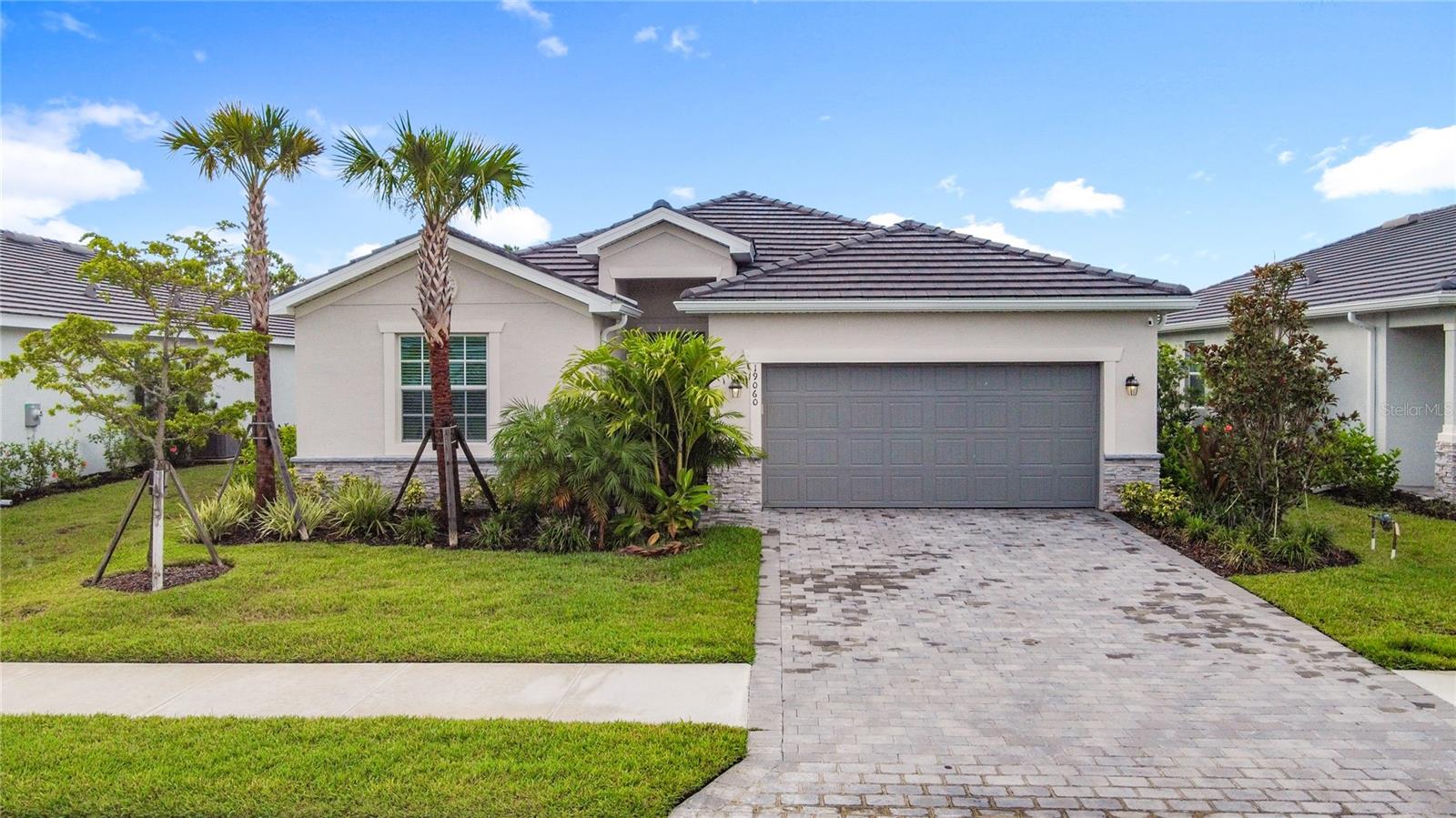 In the serene and secure neighborhood of Antigua at Wellen Park, this exquisitely crafted Trevi II home by Lennar stands as a testament to luxurious yet low-maintenance living. This single-story residence skillfully balances elegance with functionality, boasting a layout that harmonizes the dining area, kitchen, and family room into a cohesive space that gracefully transitions to a lanai, offering a heightened indoor-outdoor living experience. The house features four deluxe bedrooms, highlighted by a majestic owner's suite complete with a tranquil spa-like bathroom and a capacious walk-in closet.
The residence seamlessly blends practicality with style, including a two-car garage outfitted with chic built-in Aristokraft cabinets, a workbench, storage solutions, and an epoxy-coated floor for durability. Attention to detail prevails throughout the home with high-impact windows for tranquility and safety, alongside premium kitchen upgrades. The kitchen boasts Aristokraft Winstead shaker cabinets with soft-close doors, dovetail full-extension soft-close drawers, real wood painted finishes, and custom features like a built-in refrigerator, waste bin, and rollout shelves. This culinary space is complemented by sophisticated quartz countertops on the vanities, enriching the home's refined aesthetic.
The primary bedroom, ingeniously converted into the owner's workspace, features elegantly tailored cabinetry for stylish organization, mirroring the thoughtful design seen throughout the home. Outside, a peaceful seating area offers unspoiled reserve views, secured by an aesthetically pleasing aluminum screen for enjoyment in any season.
Continuing the trend of selective amenities, the home includes advanced safety and convenience features like a Ring Video Doorbell Pro, Honeywell's T6 Pro WiFi thermostat, and a smart lock on the front door. The exterior promises lasting durability with a tile roof, sturdy front door, and hurricane-rated garage door, ensuring both security and curb appeal.
Cabinetry elsewhere in the home maintains the high standards of style and quality, with Aristokraft Winstead stained quill cabinets in both the master bath and the closet, offering the convenience of soft-close mechanisms. The guest bath introduces a pop of color with Aristokraft Winstead painted blue cabinets, maintaining the house's commitment to elegance and functionality.
This Trevi model residence in Antigua at Wellen Park epitomizes upscale, carefree living, underpinned by the reputable craftsmanship of Lennar and the thoughtful selection of finishes and storage solutions throughout. Importantly, this property is absolutely out of the flood zone, eliminating the need for flood insurance and providing peace of mind to its occupants.