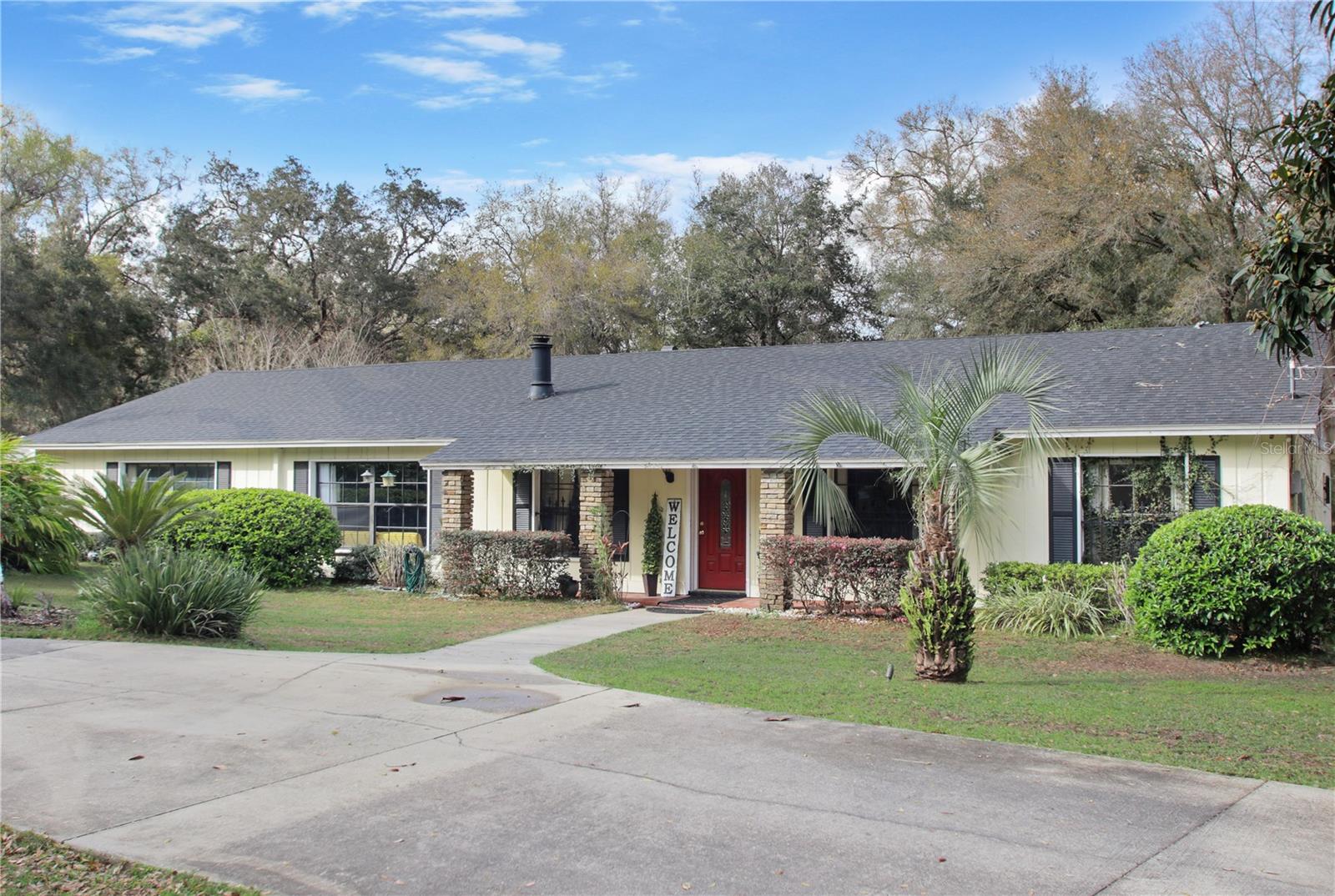 BRING YOUR HORSES!! Beautiful 2.5 acres of privacy. Two electronic gates welcome you to this lovely 3207 sq ft home. Circular horseshoe driveway invites guests with easy access for parking. Unique 5 bedroom, 3 bath home with spacious rooms. Upon entering this well maintained home, the office will be to your left with a beautiful stone wood burning fireplace. Kitchen is a chef's delight with 42 inch cabinets with crown molding, stainless steel appliances, stone countertops, pot filler faucet, commercial kitchen exhaust system and Bosch gas range. Holidays will be spectacular for large family and friend gatherings! The Dining area with tongue and groove wood ceiling accommodates a very large table and family room brings warmth with the beautiful stone, wood burning fireplace and sconces. Primary bedroom has a serene setting with plantation shutters and sliders that lead to the outdoor screened porch. There is also an additional bedroom with a bathroom ensuite. Secondary bedrooms are generous in size. The roof was replaced in 2019 and the HVAC is only 2.5 years old. Enjoy the outdoor living with 20 x 20 ft slab with firepit. 220v line is there to accommodate a spa. Carport for additional protection for vehicle, etc. Walking distance to elementary and middle school. Zoned AG. No HOA. Less than five minutes away from SR429, 30 mins from Orlando and two miles from the amphitheater at the Northwest Recreation Complex which hosts concerts and festivals. DON'T miss this magnificent property!
