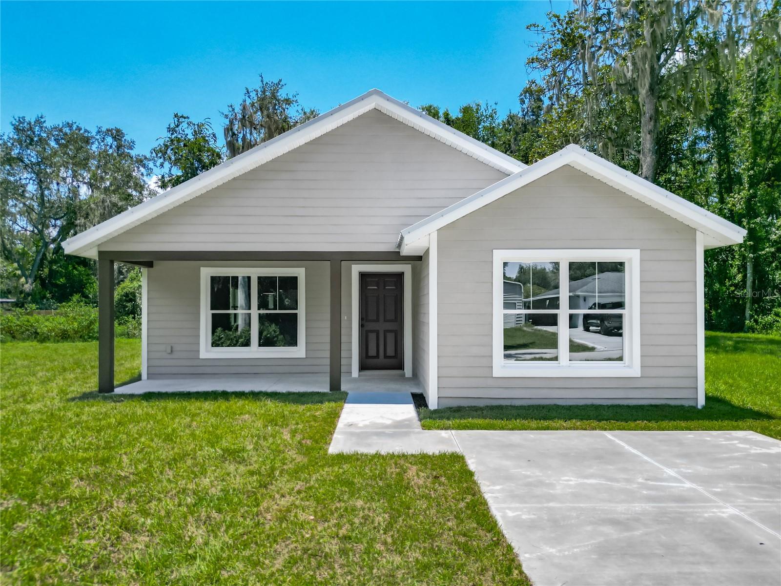 Under Construction. Brand New Construction!! Welcome to your future home in peaceful Lake Panasoffkee—a beautifully designed 3-bedroom, 2-bathroom single-family residence set on an oversized 0.34-acre lot with a lovely view of Lake Panasoffkee! Featuring 1,561 square feet of carefully planned living space, this home offers the perfect blend of rural tranquility and modern comfort. A similar model is for sale right next door, offering additional options for families or friends looking to live nearby! Once completed, every inch will showcase quality craftsmanship and thoughtful design. You’ll love the stucco lap siding, durable metal roof, and high-end finishes throughout—including handmade wood cabinetry, granite countertops, and elegant tiled shower walls. Step inside to a bright, open-concept floor plan that fills with natural light and flows effortlessly for everyday living or entertaining. The spacious kitchen opens to the main living and dining areas, creating a warm, welcoming space for family and friends. But the real magic awaits outdoors—enjoy a freshly sodded yard, a private fenced-in space, and gorgeous views of Lake Panasoffkee just beyond your doorstep. Whether you're sipping your morning coffee or winding down at sunset, the calming lake vista adds a daily dose of serenity. Located just seconds from the lake, you’ll have easy access to world-class fishing, boating, and scenic outdoor adventures, while staying close to local shops, dining, and essential services. This is more than just a home; it’s your private escape. Construction is already underway—don’t miss the chance to own this stunning new build with a lake view in the heart of Florida living. Secure it now before it's gone!