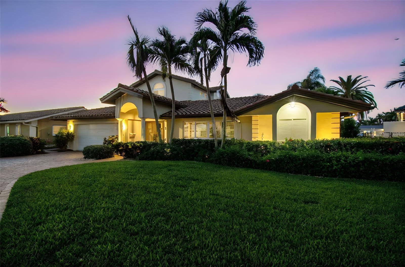 Welcome to this beautifully renovated executive residence located in one of the Bay Area’s most desirable boating communities, Venetian Isles. Perfectly positioned on a spacious lot at the end of a quiet cul-de-sac, this four-bedroom, four-bath, two-car garage pool home has been completely remodeled and is truly move-in ready. The open-concept kitchen is designed for entertaining, featuring a wet bar, granite counters, stainless steel double ovens, and a gas cooktop. The first floor offers generous living areas filled with natural light along with three bedrooms, two with en-suite baths, and a third full bath that also serves the pool area. Upstairs, the expansive master suite is a private retreat with vaulted ceilings, a spa-inspired bathroom boasting a Jacuzzi tub, walk-in shower, dual sinks, custom cabinetry, granite counters, and stained-glass accents. The suite also includes a private office with custom built-ins for two, an oversized walk-in closet, and a balcony spanning the back of the home with sweeping waterfront views. Outdoor living shines with a saltwater pool surrounded by lush tropical landscaping, covered dining and lounge areas, and an updated dock with a 16,000-pound boat lift plus a lower platform for kayaks and paddleboards. The home sits on deep sailboat water with no bridges to contend with, offering direct Gulf access. Recent updates provide comfort and peace of mind, including a new tile roof (2025), hurricane-rated windows and doors, plantation shutters, newer seawall, two Trane A/C units, a whole-house Generac generator, STILTZ elevator, LED lighting, and a mini-split A/C in the garage laundry room. With quick access to downtown St. Petersburg, world-class beaches, shopping, dining, and airports, this home is the perfect combination of luxury, convenience, and Florida waterfront living. Call today to schedule your private showing.