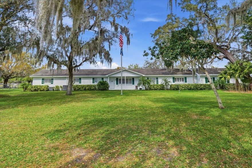 This exceptional property offers the best of both worlds — the peace and space of country living, with the convenience of city amenities just minutes away. Set on just under 10 acres, this is a beautiful horse farm with room to live, work, and enjoy.
The main home features a spacious open floor plan with 3 bedrooms plus a separate office, gym, and laundry room, all thoughtfully laid out with comfortable living in mind. Attached to the home, but with its own private entrance, is a mother-in-law suite with three rooms and a half bath, as well as wood flooring, making it a wonderful flexible space for extended family, guests, hobbies, or a home business.
Outside, the property continues to impress with a beautiful chlorine deep pool with a diving board for added fun. The grounds are well-equipped for both everyday living and farm use, including horse barns and stables, a corral, hay barn, chicken coop, workshop with hydraulic car lift, three storage rooms/garages with electric doors, covered RV parking for two, and an electric front gate. The fencing is non-climb wire fencing, ideal for horses.
Additional features include 3 AC units with 4 zones, serviced twice per year, a generator connected to an underground propane tank, 2 wells, and 4 septic tanks.
This is a special property for anyone seeking a true horse farm lifestyle without sacrificing convenience. Located near Citrus Park Mall, shopping, dining, and everyday services, and approximately 20 minutes from Tampa International Airport, as well as dinner and sunset on the Gulf of Mexico, this property offers the feel of country living with the city close by. Schedule your private showing and come experience all this fantastic property has to offer.