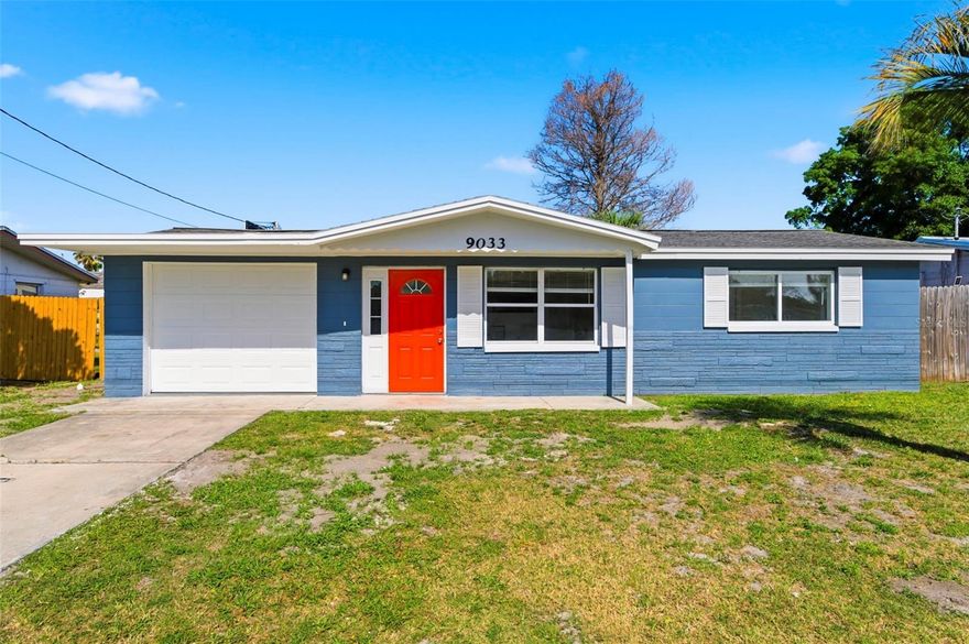 WELCOME TO YOUR TROPICAL PARADISE at 9033 Pegasus Ave, Port Richey, FL in the Holiday Hills subdivision. This RENOVATED home consists of 3 bedrooms, 1 bathroom & oversized 1 car garage in a NO HOA or NO CDD zone. Key exterior features are FRESH paint in a Mediterranean sea-blue color, BRIGHT coral color front door, mature palm trees, covered front porch, carriage lights, rain gutters, concrete driveway, like-new mailbox & FULLY FENCED YARD. The systems of the house are all updated: Water Heater (1/2024); AC (7/2023); Roof (3/2014) & JUST COMPLETED conversion from underground cast iron piping to PVC piping. As you step inside, you'll LOVE the NATURAL SUNSHINE ILLUMINATING the interior together with the updated light fixtures. Many of the windows have been replaced with double-pane windows & dressed with custom fitted blinds. The OPEN FLOOR PLAN consists of the kitchen, living & dining rooms. The walls are freshly painted in a CRISP COLOR & feature crown molding as well as beadboard design with chair rail. The GORGEOUS PORCELAIN WOOD-LOOK TILES flow elegantly throughout the entire home making the space feel brighter & larger. The REMODELED kitchen consists of BRAND NEW stainless steel appliances by LG including a fridge, range & microwave. The shaker-style, soft-close cabinets have 1/2 moon knobs or cylindrical handles in a JET black color. More BEAUTIFUL features in the kitchen include SHIMMERY QUARTZ COUNTERS, recessed lights, pass-through opening to the living room & a deep double stainless sink. Enjoy a lovely meal in the dining area or your private yard outside. After a long day, retreat to your primary bedroom which can accommodate king-size furniture & has ample closet space. The second bedroom is located nearby while the third bedroom is found on the opposite wing of the home. This LOVELY bedroom has double-French doors, closet & built-in bookshelves adding to the charm. The FABULOUS bathroom features a subway-tiled shower, rain shower head, new vanity cabinet, QUARTZ COUNTER matching the kitchen counters, MODERN towel racks, complimentary plumbing fixtures, linen closet in the hall & triple pendant light. More MARVELOUS details include newer 6-panel interior doors, matching doorknobs, semi-circle window on the front door for more light, wood framed windows for added texture, some marble window sills, LED lights & shade shutters over some of the windows for storm safety. In the OVERSIZED garage, you'll find the laundry hookups, side door access, automatic garage door opener, epoxy concrete floor & a window for natural light. Location is IDEAL near schools, beaches, medical plazas, shopping centers, restaurants, places of worship, airport & tourist attractions. MAKE THIS YOUR FUTURE HOME!