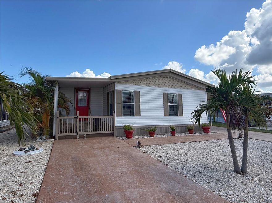 NEW PRICE! This is your opportunity to own a beautiful retirement or seasonal home in Florida! Tastefully UPDATED, the home was untouched by the recent hurricanes. Located in the 55+ waterfront community of Caribbean Isles Residential Cooperative in Apollo Beach, the property features a spacious split-bedroom layout, with both bedrooms offering ensuite bathrooms for added privacy. The kitchen includes new cabinets, stainless steel appliances, and a large island with counter seating, opening to the dining area. The living room features a vaulted ceiling and a decorative built-in FIREPLACE. High-end Luxury Vinyl Plank flooring runs throughout the home—NO CARPET. The fully enclosed Florida room includes its own AC unit, providing additional climate-controlled living space. Recent updates include fresh interior and exterior paint, a new roof over with added insulation, and a water filtration system. The purchase includes a Share in the Cooperative, meaning NO LOT RENT. Community amenities include a heated pool, clubhouse, game room, craft room, library, organized events throughout the year, on-site laundry, dog park, boat and kayak launch, and four miles of roads for walking, biking, or golf cart use. Professionally managed and well maintained, this is resort-style living at its best. The monthly maintenance fee is just $242.00, which covers all of this.  Bring your boat or RV to store in the onsite storage lot for only $120 to $250 annually.