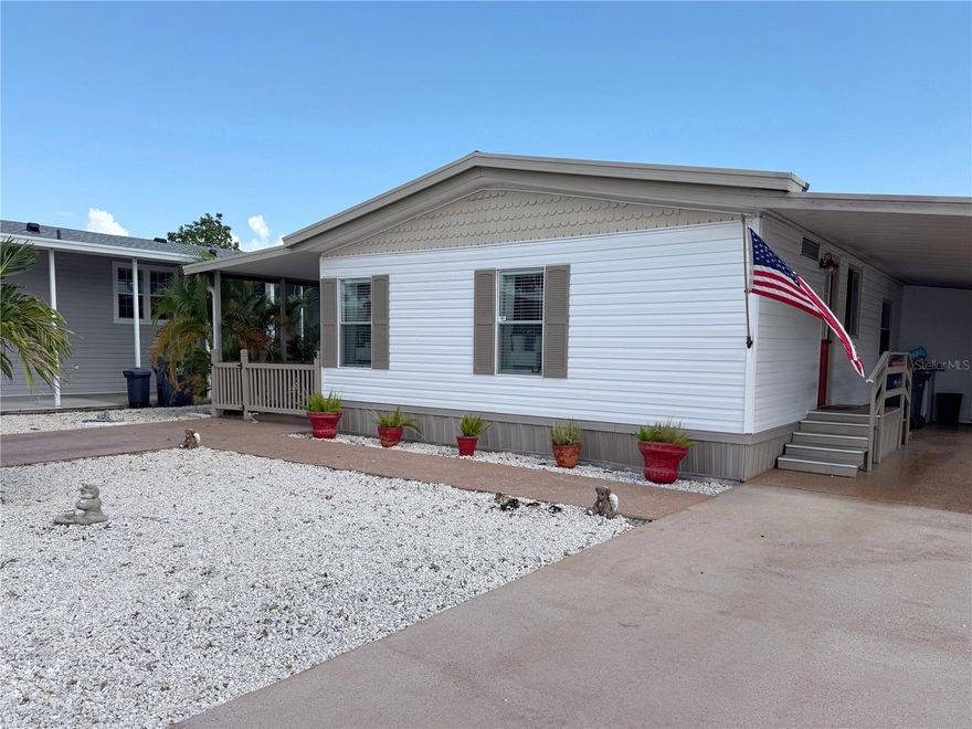 This is your opportunity to own a beautiful retirement or seasonal home in Florida! Tastefully updated, the home was untouched by the recent hurricanes. Located in the 55+ waterfront community of Caribbean Isles Residential Cooperative in Apollo Beach, and move-in-ready, the property features a spacious split-bedroom layout, with both bedrooms offering ensuite bathrooms for added privacy. The kitchen includes new cabinets, stainless steel appliances, and a large island with counter seating, opening to the dining area. The living room features a vaulted ceiling and a decorative built-in fireplace. High-end Luxury Vinyl Plank flooring runs throughout the home—no carpet. The fully enclosed Florida room includes its own AC unit, providing additional climate-controlled living space. Recent updates include fresh interior and exterior paint, a new roof over with added insulation, and a water filtration system. The purchase includes a Share in the Cooperative, meaning NO LOT RENT. Community amenities include a heated pool, clubhouse, game room, craft room, library, organized events throughout the year, on-site laundry, dog park, boat and kayak launch, and four miles of roads for walking, biking, or golf cart use. Professionally managed and well maintained, this is resort-style living at its best. The monthly maintenance fee is just $242.00, which covers all of this.  Bring your boat or RV to store in the onsite storage lot for only $120 to $250 annually.