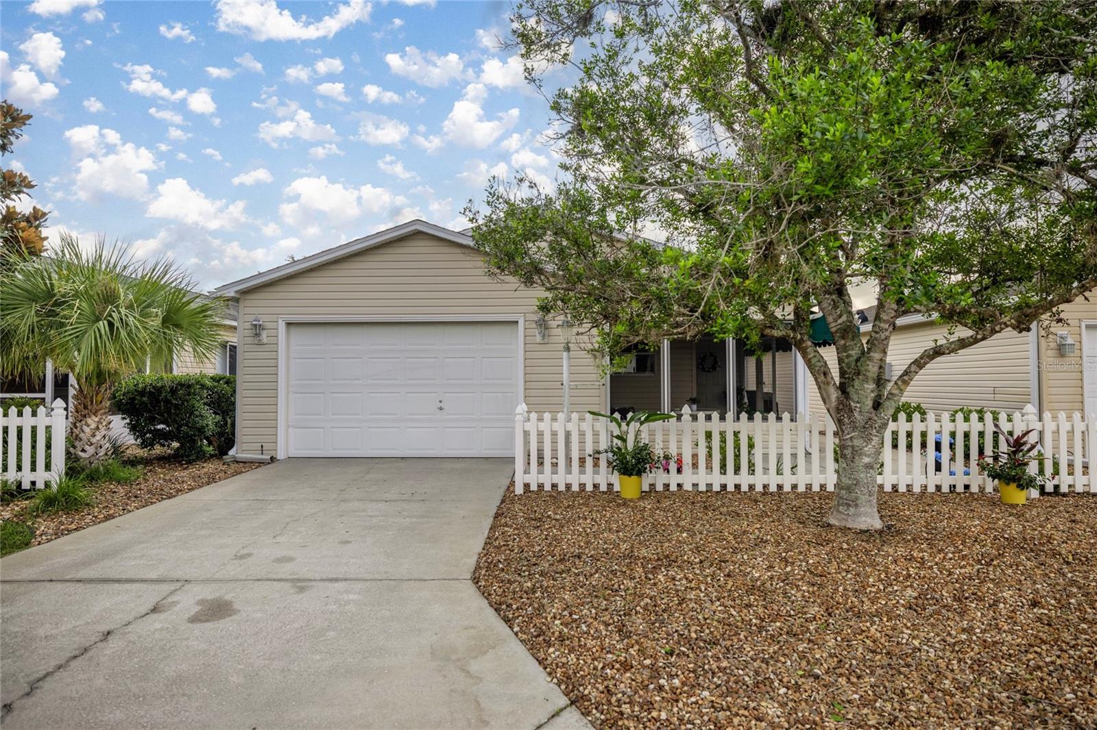 This professionally renovated 1-bedroom, 1-bath villa in The Villages is the definition of move-in ready—no projects, no updates needed! Every detail has been thoughtfully upgraded, so you can start enjoying the lifestyle from day one.
The interior features brand-new luxury vinyl plank flooring, fresh interior paint, updated baseboards, and stylish new light fixtures. The kitchen is a showstopper with all-new cabinetry finished in brushed gold, solid surface Corian countertops, a spacious refrigerator, a sleek single-bowl waterfall sink with coordinating gold accessories, and a classic white subway tile backsplash that adds a clean, timeless touch.
The bathroom offers a spa-like retreat with a modern floating vanity and updated gold hardware for a touch of everyday luxury. Remote-controlled ceiling fans have been installed in the living area, bedroom, and enclosed lanai for year-round comfort.
Outside, the home has been freshly landscaped with low-maintenance landscaping and an irrigation system to keep everything looking its best with minimal effort. Major updates include a roof replaced in 2018, HVAC in 2013, and newer siding.
No Bond—fully paid off! Washer and dryer are included, and the optional furniture package makes it even easier to start living the Villages lifestyle right away.
