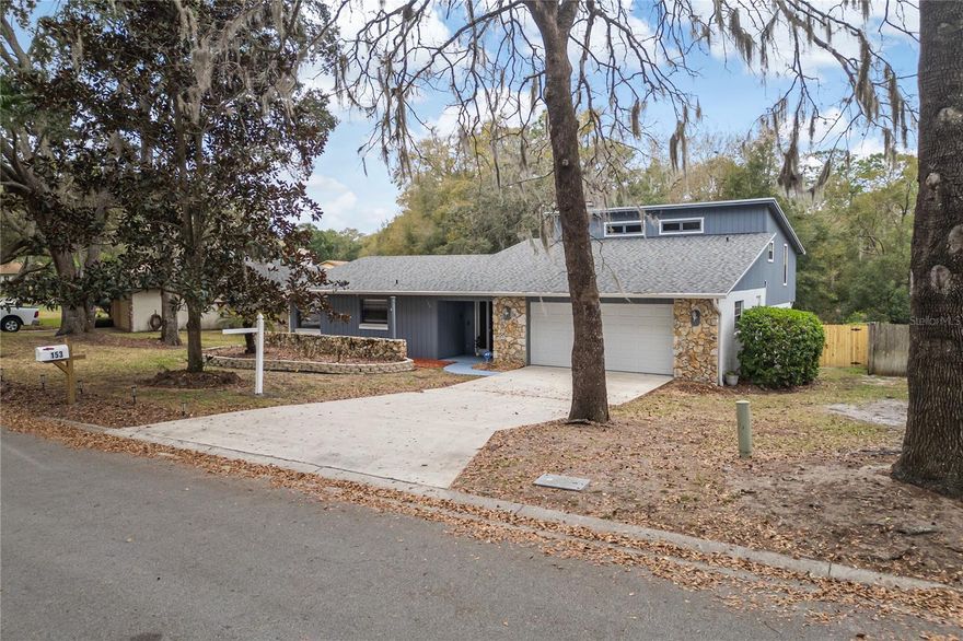 There are homes that simply provides space… and there are homes that invite you to slow down and enjoy it. Welcome to 153 Duncan Trail, a distinctive multi-level residence tucked into one of the most peaceful corners of Longwood. Set on a generous ¼ acre lot with no rear neighbors, this 3-bedroom, 2-bath home with 2,596 sq ft offers privacy, character, and room to live in ways that many newer homes simply can’t replicate. From the moment you step inside, the home reveals its personality. The main living room centers around a charming fireplace, creating a warm focal point before the space opens toward the backyard deck. It’s the kind of room that naturally becomes the heart of the home, whether it's a quiet evening by the fire or gathering with friends before stepping outside. The kitchen has been remodeled (2017) and sits comfortably alongside the dining area. The dining space feels almost like an interior balcony, overlooking the living areas and adding visual openness and architectural interest. Nearby, a spacious dinette and laundry room with washer and dryer make daily life practical and convenient. The layout unfolds across three levels, creating natural separation between living and resting areas. Two bedrooms are located on the lower level, while the primary suite occupies the upper level, offering a sense of retreat from the rest of the home. The primary bedroom is oversized, with plenty of room not only for furniture but for a reading corner, workspace, or private sitting area. A sliding door opens to an elevated outdoor view above the covered porch roof, an unexpected architectural feature that allows natural light and a quiet connection with the outdoors. Step outside and the experience continues. An enclosed back porch with large storage space transitions to an open deck surrounded by nature, where mornings can start with coffee and the sound of birds coming from the conservation behind the property. The backyard also features a dedicated fire-pit area, perfect for evenings under the Florida sky. The property backs up to lush conservation, creating a peaceful natural backdrop. There is even potential for the next owner to enhance the connection with nature by adding a gate from the patio area for easier access to the conservation behind the home. Practical details haven’t been overlooked. Major system upgrades have already been completed, including a new architectural roof and gutters (2024), full-home PEX repiping (2024), and a Carrier A/C system installed in 2022, water heater replaced in 2020, fireplace last inspected 2020, Bathrooms remodeled (2017), Interior paint (2025) providing peace of mind for years to come (Last serviced summer 2025). The two-car garage is exceptionally well maintained, finished with an epoxy floor and a functional workbench, ideal for projects, storage, or anyone who appreciates an organized workspace. Homes like this delivers something rare: space, privacy, character, and opportunity, all in one of Central Florida’s most established communities.