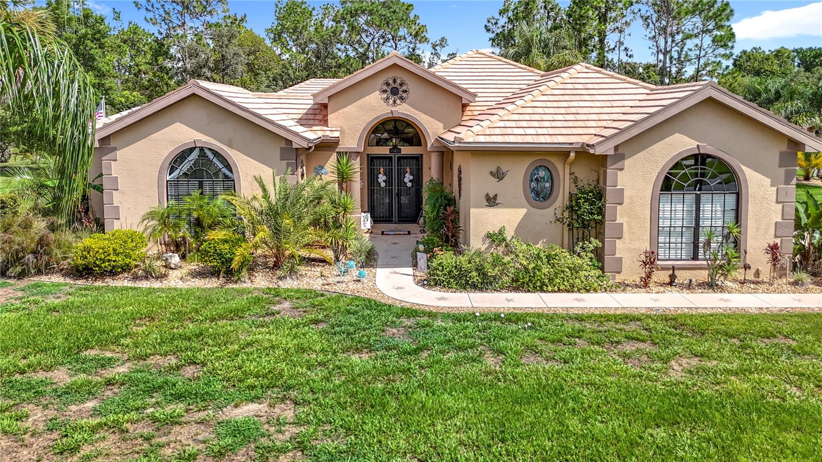 Stunning 3 bedrooms + office, 3 bath + 3 car garage Cabana Pool Home located in the desirable Sugarmill Woods Community! The lot on Linder is included in the sale for a total of .71 acres!! For added privacy, one of the bedrooms is a separate en-suite and resides in a separate Casita across the courtyard, great for guests or as an IN-LAW suite. The elegance of this home begins the moment you arrive. The double door entry sets the tone for its grandeur, offering a warm and inviting welcome while hinting at the beautiful space within. Imagine stepping into a home that feels like a retreat—a sanctuary where every detail has been designed to provide an unparalleled sense of comfort and style. This stunning cabana pool home is a masterpiece of modern living, offering a host of luxurious features that perfectly blend practicality with aesthetic appeal. The heart of this home is undoubtedly the expansive kitchen, designed with Corian counters and equipped with modern stainless-steel appliances. This space combines elegance with practicality, offering ample counter space for meal preparation and casual gatherings. Step inside the spacious living room, where the trey ceiling and custom built-in shelving immediately captures your attention. Expansive glass- enclosed Florida offers panoramic views of the beautifully manicured yard, with a paver patio, a pergola with fire pit, built-in stone grilling station with a Blackstone grill, and a fenced yard. No cabana pool home would be complete without a summer kitchen, and this home delivers in style. Equipped with a wet bar, this outdoor culinary space is ideal for hosting barbecues, pool parties, or intimate alfresco dinners. The summer kitchen seamlessly blends functionality and luxury, making it a space where cooking and entertaining become a pleasure rather than a chore. This home offers an array of additional features to include 50-year tile roof, AC 2017, solar heated pool, 4-person hot tub, pavers lanai and pool deck, newer 220 breaker, each bedroom with pool access, well for sprinklers, central vac, and a 10X10 shed equipped with electric. Lots of shopping and favorite local dining options nearby. Transferable home warranty in place until 8/29/2029. It is conveniently located near Homosassa Springs, Citrus County’s Nature Coast and close to the Gulf to enjoy fishing, boating, Kayaking and so much more. Sugarmill Woods Country Club offers a variety of amenities, including two golf courses, tennis courts, pickleball courts, a gym, a Jr Olympic-sized swimming pool, a tiki bar, and a restaurant. Easy access to the Suncoast parkway for quick access to the airport, Tampa, Clearwater and St. Pete Beaches (Ranked in the top 5 Beaches in the US), also close to the famous Tarpon Springs Sponge Docks. Enjoy everything Tampa Bay has to offer from the new Downtown Riverwalk, TOP US BEACHES, boating, fishing, golfing, cultural entertainment, and museums...and of course beautiful year-round weather! ASK YOUR AGENT FOR THE DETAILED FEATURE LIST ATTACHED.